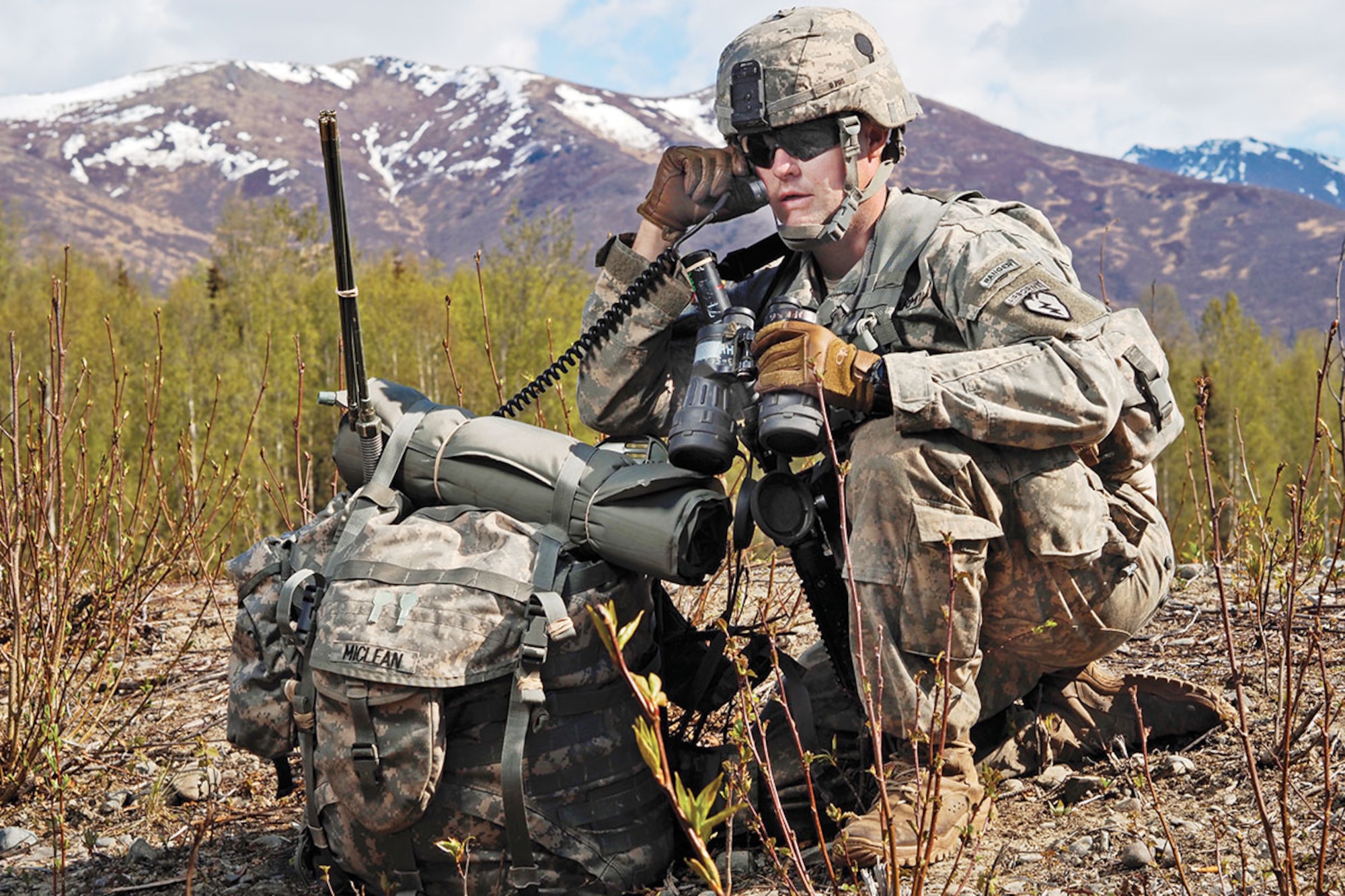Spc. Matthew Miclean, a forward observer assigned to Headquarters and Headquarters Battery, 2nd Battalion, 377th Parachute Field Artillery Regiment, 4th Infantry Brigade Combat Team (Airborne), U.S. Army Alaska, is seen with his equipment during a brigade field exercise,  May 12. (U.S. Air Force photo/Justin Connaher)