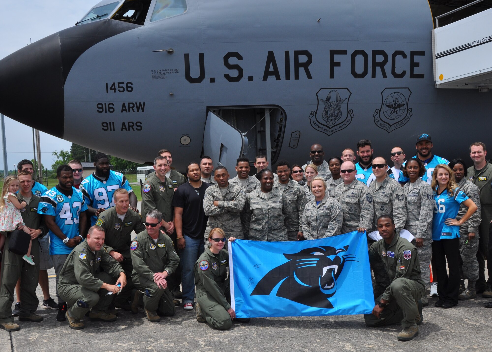 916th Air Refueling Wing Airmen join Carolina Panthers players and cheerleaders in front of a KC-135R Stratotanker at Seymour Johnson Air Force Base, North Carolina, May 15, 2015. Members of the Panthers organization toured base facilities, signed autographs and met with fans as part of the Wings Over Wayne Airshow kick-off festivities. (USAF photo by Master Sgt. Wendy Lopedote, 916ARW/PA)
