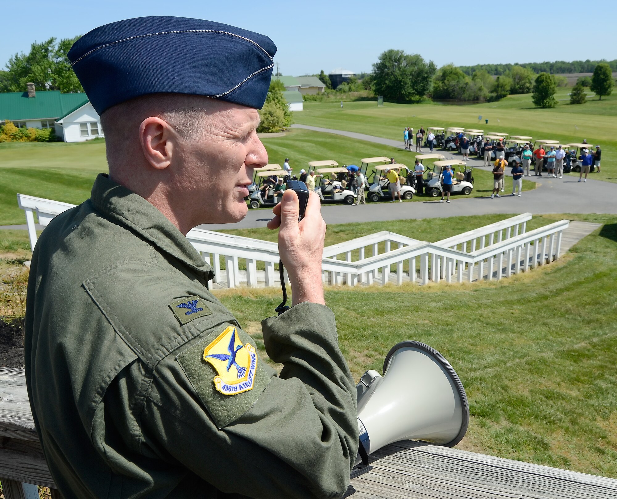Col. Michael Grismer, 436th Airlift Wing commander, uses a bullhorn to address participants in the semi-annual Dover Bluesuiters Golf Tournament before their start May 14, 2015, at Jonathan???s Landing Golf Course in Magnolia, Del. Key military leaders from Dover Air Force Base were paired with local civic and business leaders for the tournament as part of Dover AFB's robust community outreach program. (U.S. Air Force photo/Greg L. Davis)