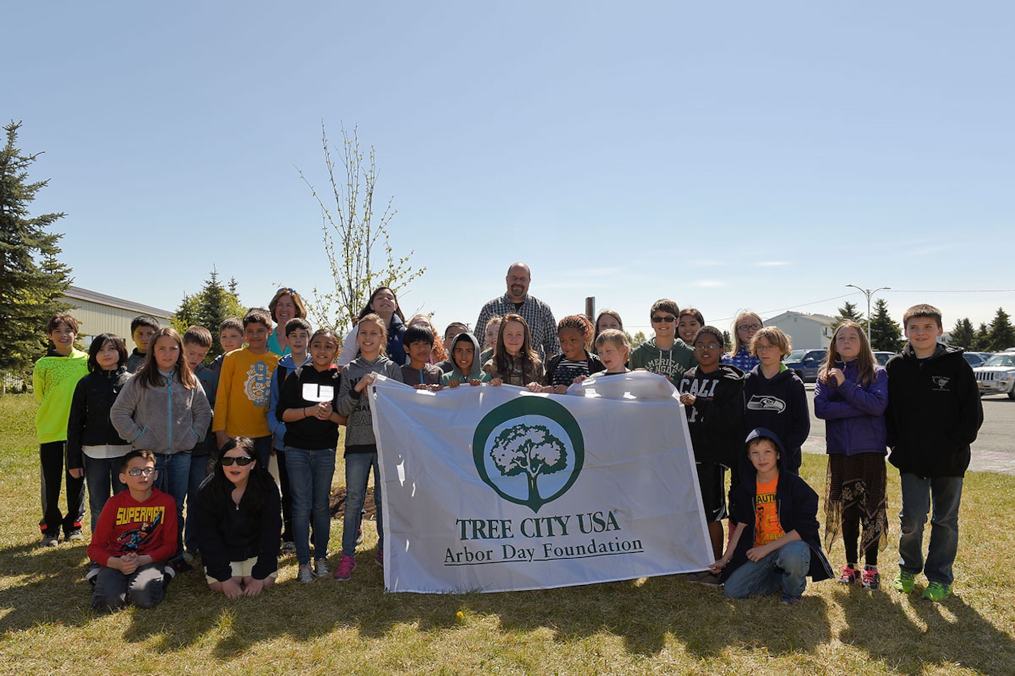 Aurora Elementary School 5th grade students celebrate Arbor Day by planting a tree on Joint Base Elmendorf-Richardson May 18. 673d Air Base Wing and JBER commander Air Force Col. Brian Bruckbauer, Alaska State Community Forester Stephen Nickels and JBER ecologist Charlene Johnson were on hand to deliver remarks and information regarding Alaska trees and the importance of environmental conservation. (U.S. Air Force photos/Alejandro Pena)