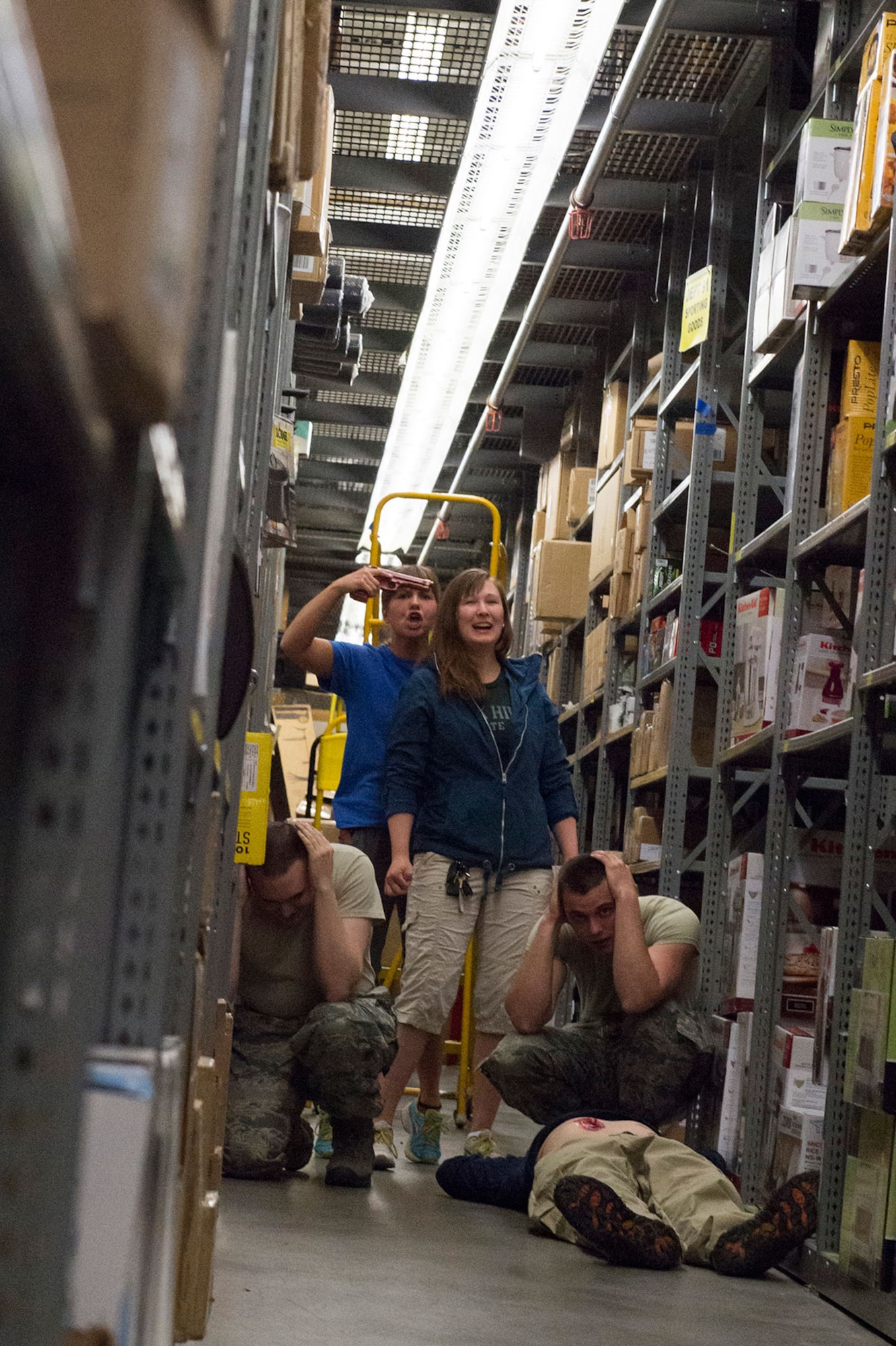 Role players simulate an active shooter scenario while participating in high risk response training at the base exchange on Joint Base Elmendorf-Richardson, Alaska, May 15, 2015. Pacific Air Forces High Risk Response Training is a project that provides security forces personnel with an intensive course based in real-life scenarios emphasizing effective tactics to eliminate active shooters and other threats. (U.S. Air Force photo/Alejandro Pena)