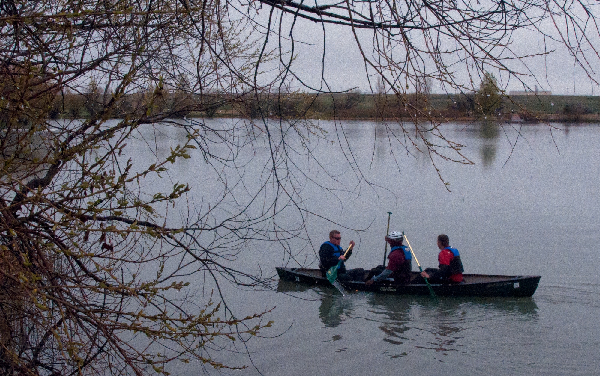 Master Sgt. Charles Pearce, Tech. Sgt. Ernest Poore and Tech. Sgt. Robert Trotter paddle across the F.E. Warren Air Force Base, Wyo., base lake during the 90th Force Support Squadron’s Amazing Race competition May 20, 2015. Teams had to complete various obstacles around base, ranging from painting a picture to physical exercises. (U.S. Air Force photo by Staff Sgt. Jeffery Daniel) 