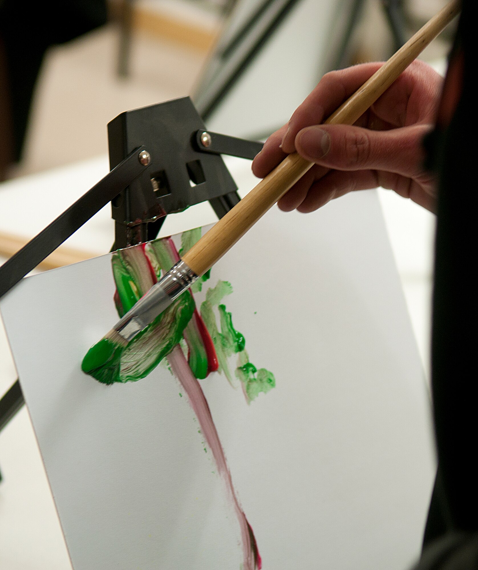 Ninetieth Communications Squadron Airmen attempt to team paint a tree during the 90th Force Support Squadron’s Amazing Race competition May 20, 2015. The team of Staff Sgt. Ben Hebert, Staff Sgt. Tanner Thompson and Airman 1st Class Joseph Lunt came in first place, beating out two other teams. (U.S. Air Force photo by Airman 1st Class Brandon Valle)