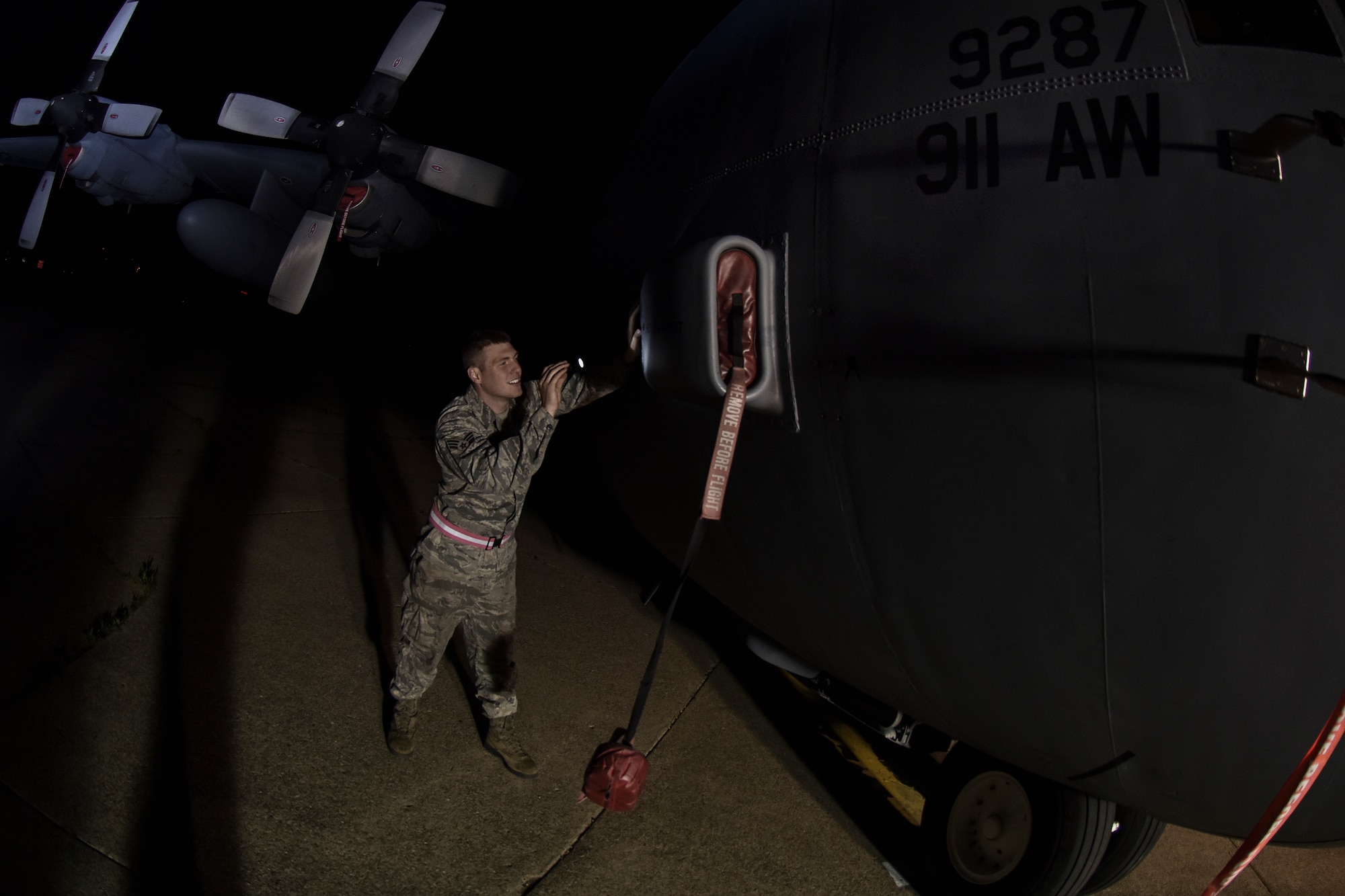 Senior Airman Jacob Francis, 911th Aircraft Maintenance Squadron crew chief, inspects the air conditioning air inlet scoop of a C-130 Hercules for leaks during a post-flight inspection here, May 21, 2015. During the post-flight inspection, crewchiefs inspect the entire aircraft ensuring there is no damage to any of the mechanical parts. (U.S. Air Force photo by Senior Airman Joshua J. Seybert)
