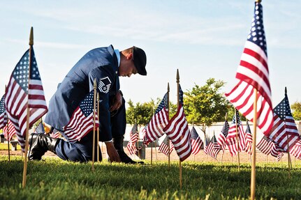 Air Force Master Sgt. Robert Lilly pays his respects to a fallen veteran May 28, 2013, at the Southern Nevada Veterans Memorial Cemetery, Boulder City, Nevada. Lilly and other Airmen from Nellis Air Force Base, Nev., volunteered their time to place flags over veterans’ cemetery plots for Memorial Day weekend. Lilly is a 57th Operations Group joint terminal air controller. (U.S. Air Force photo/Senior Airman Daniel Hughes)