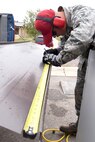 Airman 1st Class Christian Calderon, 819th RED HORSE Squadron structures shop, measures and marks wall panels May 20, 2015, at Malmstrom Air Force Base, Mont. RED HORSE's major wartime responsibility is to provide a highly mobile, rapidly deployable, civil engineering response force that is self-sufficient to perform heavy damage repair required for recovery of critical Air Force facilities and utility systems, and aircraft launch and recovery. (U.S. Air Force photo/Chris Willis)