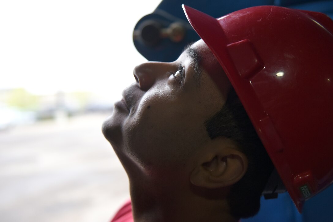 Senior Airman Trevor Sanchez, 819th RED HORSE Squadron structures shop, watches as an overhead door is installed May 20, 2015, at Malmstrom Air Force Base, Mont. The primary RED HORSE tasking in peacetime is to train for contingency and wartime operations. (U.S. Air Force photo/Chris Willis)