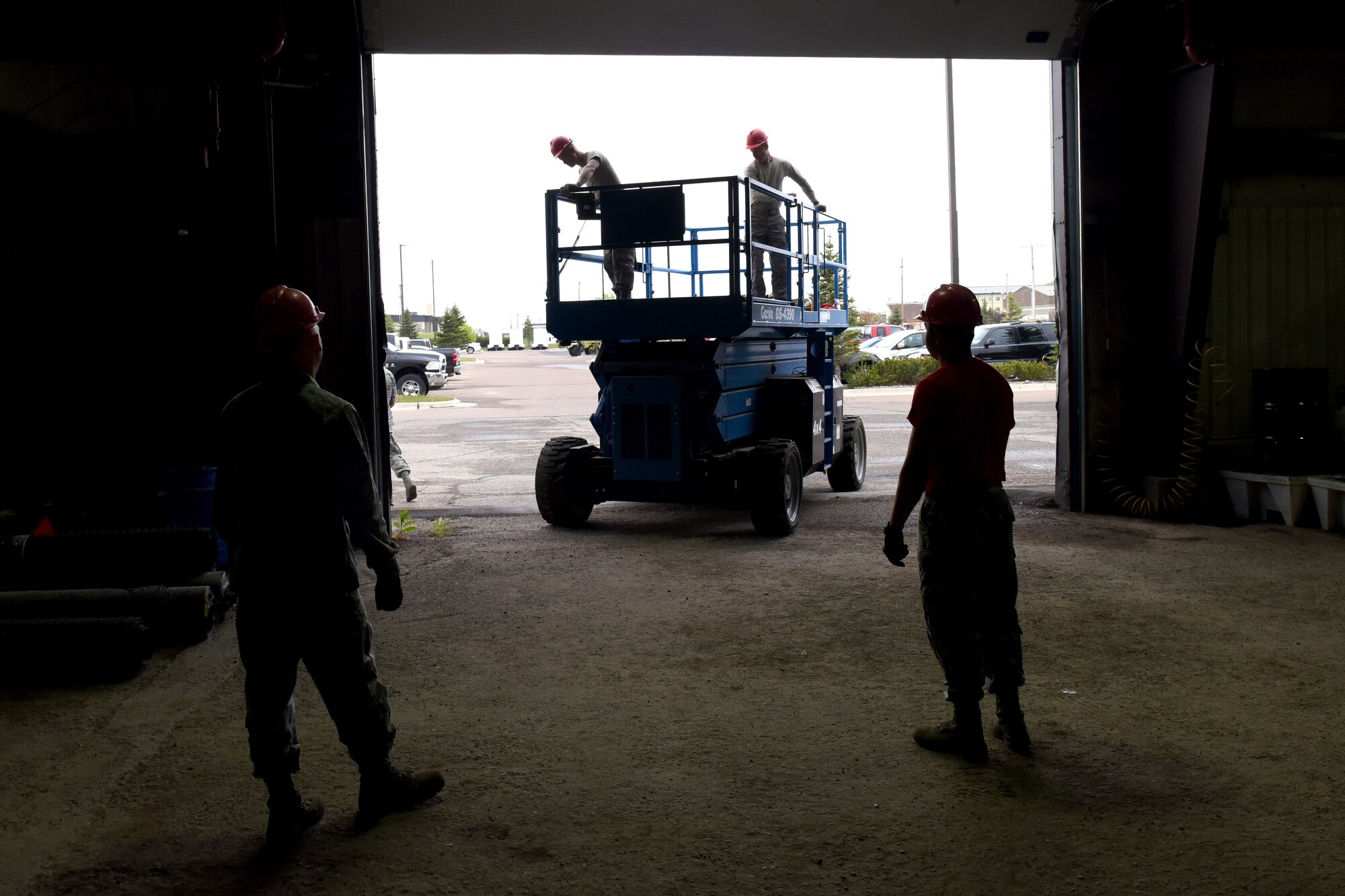 Airmen from the 819th RED HORSE Squadron structures shop prepare to install an overhead door May 20, 2015, at Malmstrom Air Force Base, Mont.  RED HORSE, or Rapid Engineer Deployable, Heavy Operational Repair Squadron, Engineer squadrons provide the Air Force with a highly mobile civil engineering response force to support contingency and special operations worldwide. (U.S. Air Force photo/Chris Willis) 