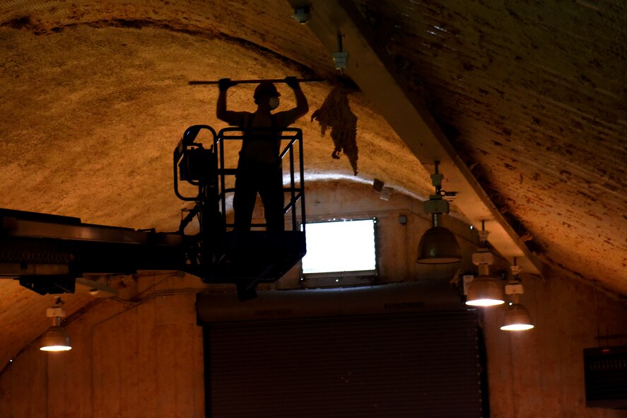 Senior Airman Skyler Maletich, 819th RED HORSE Squadron structures shop, removes old insulation on their storage facility May 20, 2015, at Malmstrom Air Force Base, Mont. RED HORSE, or Rapid Engineer Deployable, Heavy Operational Repair Squadron, Engineer squadrons provide the Air Force with a highly mobile civil engineering response force to support contingency and special operations worldwide. (U.S. Air Force photo/Chris Willis)