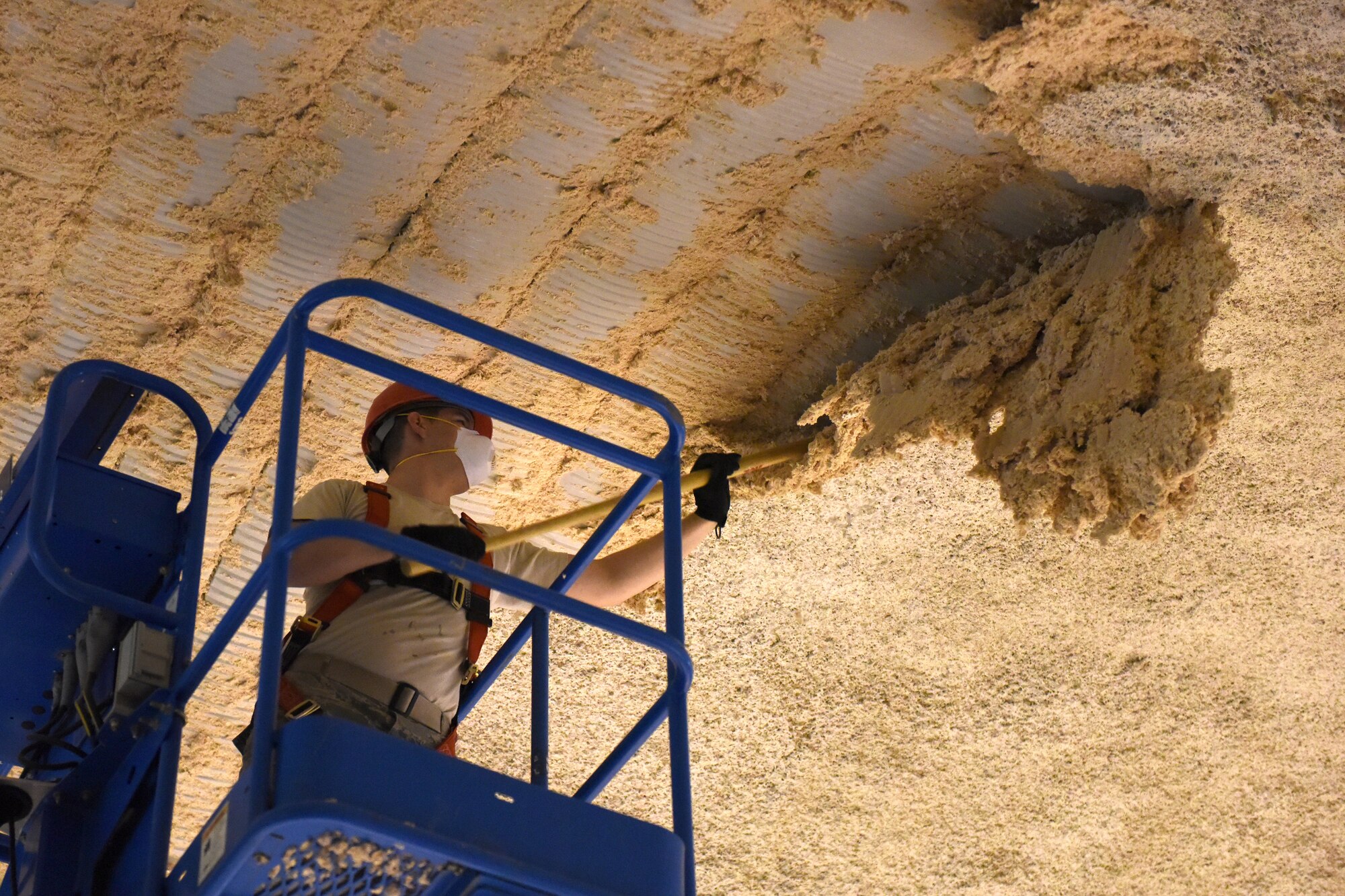 Senior Airman Skyler Maletich, 819th RED HORSE Squadron structures shop, removes old insulation on their storage facility May 20, 2015, at Malmstrom Air Force Base, Mont. RED HORSE, or Rapid Engineer Deployable, Heavy Operational Repair Squadron, Engineer squadrons provide the Air Force with a highly mobile civil engineering response force to support contingency and special operations worldwide. (U.S. Air Force photo/Chris Willis)