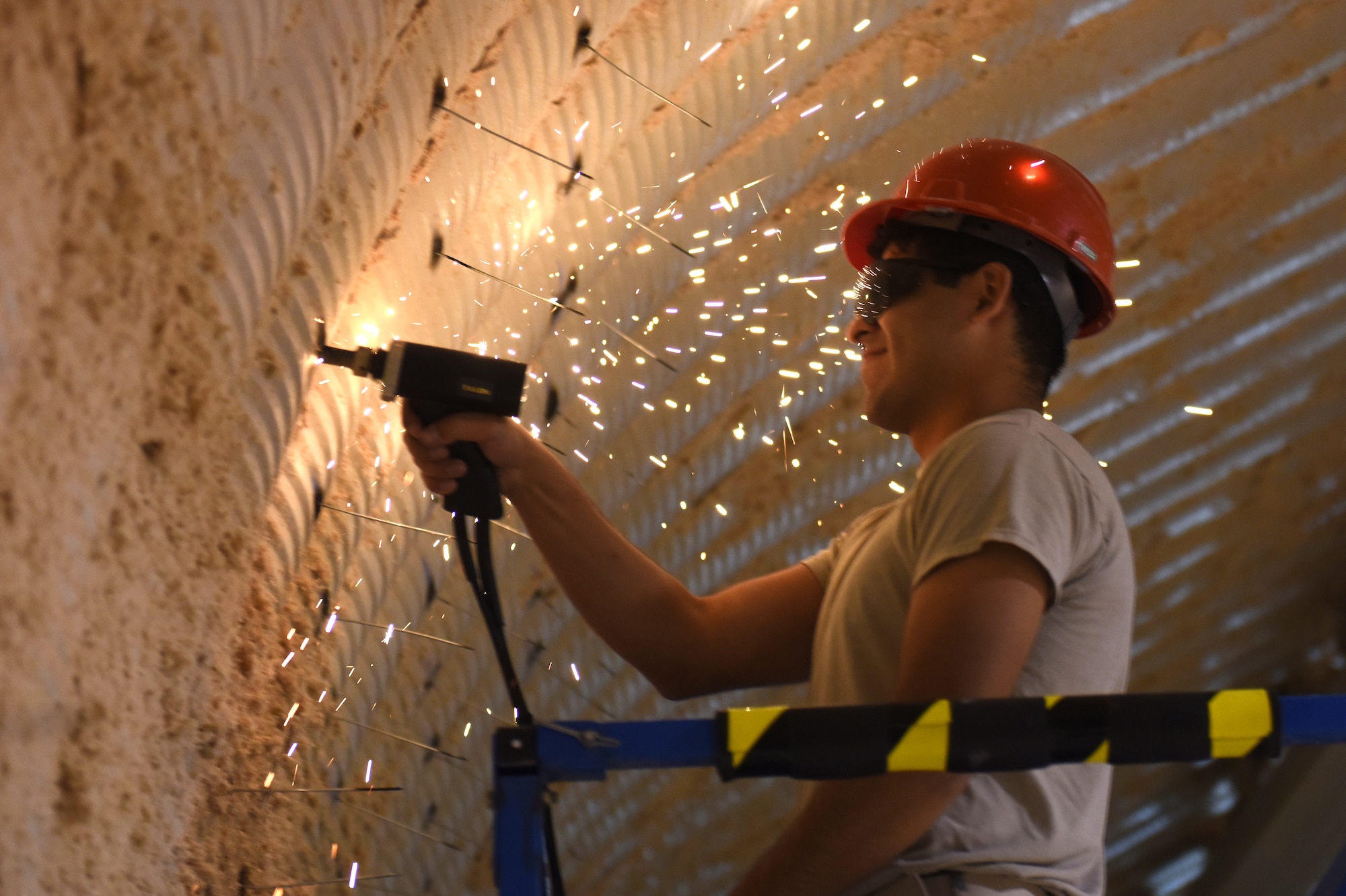 Senior Airman Daniel Torres, 819th RED HORSE Squadron structures shop, performs pin welding to install new insulation on their storage facility May 20, 2015, at Malmstrom Air Force Base, Mont. The 819th RHS provides heavy repair capability and construction support when requirements exceed normal base civil engineer capabilities and where Army engineer support is not readily available. (U.S. Air Force photo/Chris Willis)