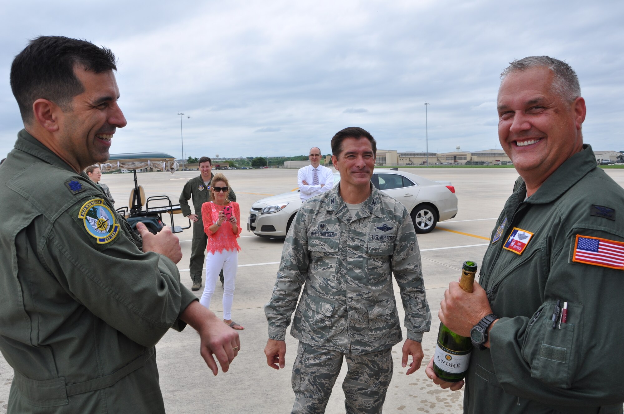Col. Jimmie "Pat" Brooks, 356th Airlift Squadron commander, is greeted by Col. William W. Whittenberger Jr. (center), 433rd Airlift Wing commander, and Lt. Col. John Niakaros, 433rd Operations Support Squadron commander after his fini flight, May 21, 2015, at Joint Base San Antonio-Lackland, Texas. Brooks leaves the "Alamo Wing" to serve as the 908th Airlift Wing vice commander at Maxwell Air Force Base, Alabama.