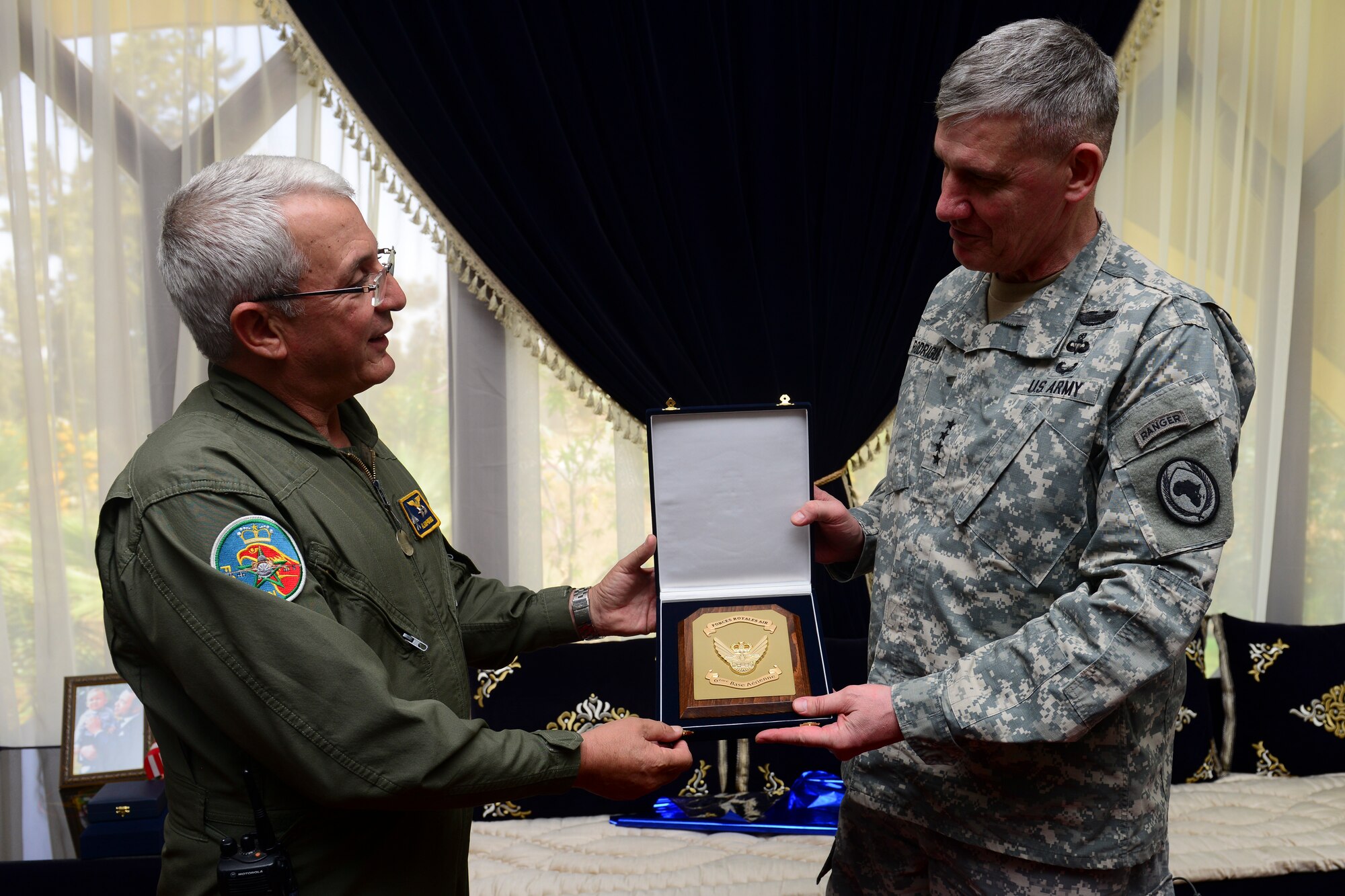 The Royal Moroccan Air Force Ben Guerir base commander, presents Gen. David Rodriguez, Africa Command commander, with a gift during a lunch meeting at Ben Guerir Air Base, Morocco, May 20, 2015. Rodriguez received a base tour and an briefing on the joint Exercise African Lion air training exercise. African Lion is an annually-scheduled, combined. U.S. -Moroccan exercise designed to improve interoperability and mutual understanding of each other’s tactics, techniques and procedures while demonstrating the strong bond between the two nation’s militaries. (U.S. Air Force photo by Staff Sgt. Eboni Reams/Released)