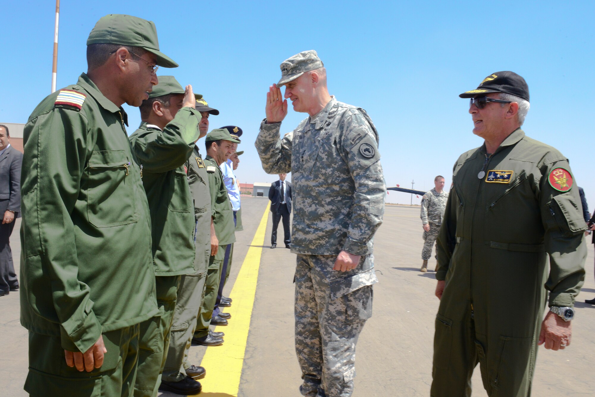 U.S. Army Gen. David Rodriguez, Africa Command commander, salutes Royal Moroccan Air Force members on the flight line at Ben Guerir Air Base, Morocco, May 20, 2015. Rodriguez received a base tour and an briefing on Exercise African Lion air training exercise. African Lion is a joint coalition exercise led by U.S. Marine Forces Europe and Africa with a mission of building partnerships and maximizing interoperability with allies.. (U.S. Air Force photo by Staff Sgt. Eboni Reams/Released)
