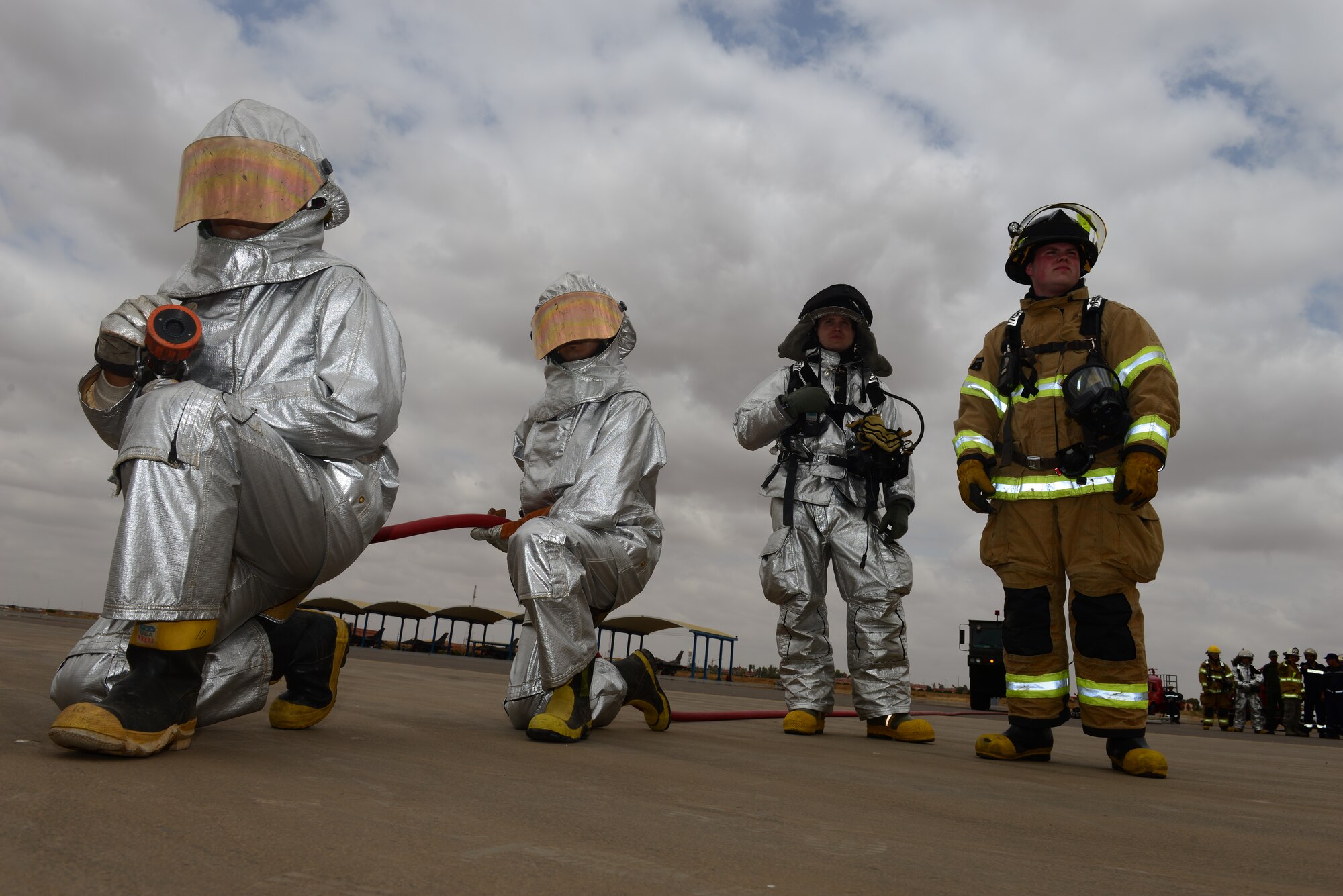 Royal Moroccan and U.S. Air Force firefighters standby in a joint hydrazine aircraft exercise during Exercise African Lion at Ben Guerir Air Base, Morocco, May 19, 2015. The exercise is a rare support element needed for an engine failure during flight than requires a toxic hydraulic fluid to be disposed of. This is the first year the U.S. Air Force has participated in the combined joint training engagement led by U.S. Marine Forces Europe and Africa. (U.S. Air Force photo by Staff Sgt. Eboni Reams/Released)