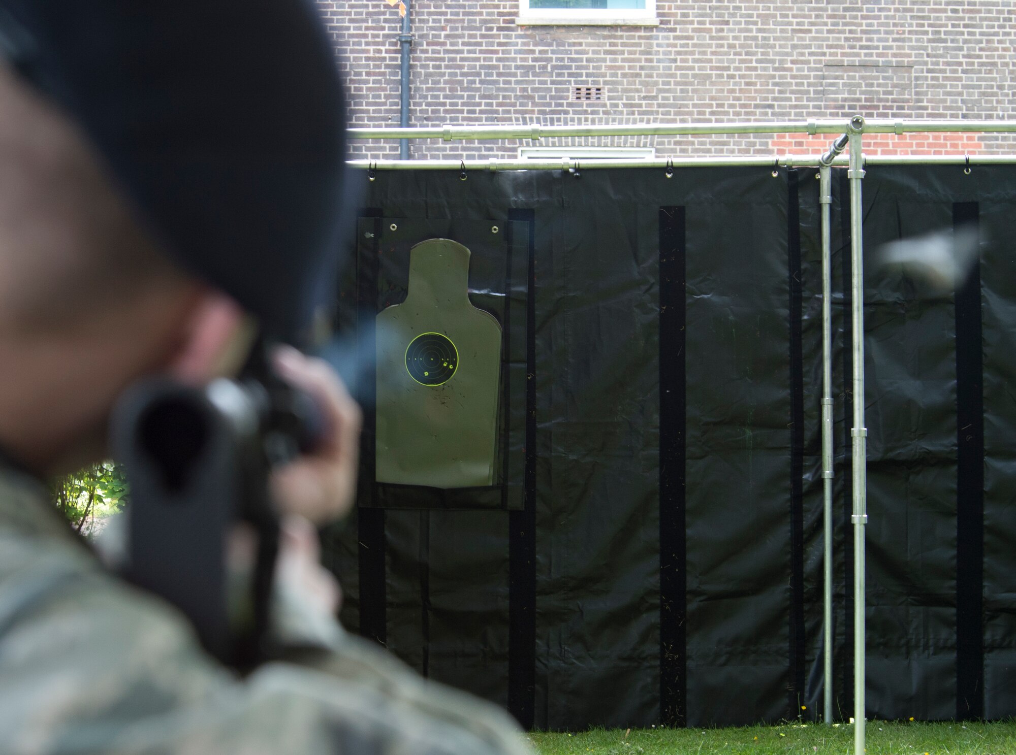 A security forces Airman fires an M-4 rifle at a target during the security forces shooting competition at Royal Air Force Feltwell, England, May 19, 2015, in honor of National Police Week. NPW was established in 1962 by President John F. Kennedy, to honor the bravery and sacrifices of the men and women who serve as police officers. (U.S. Air Force photo by Airman 1st Class Dawn M. Weber/Released)