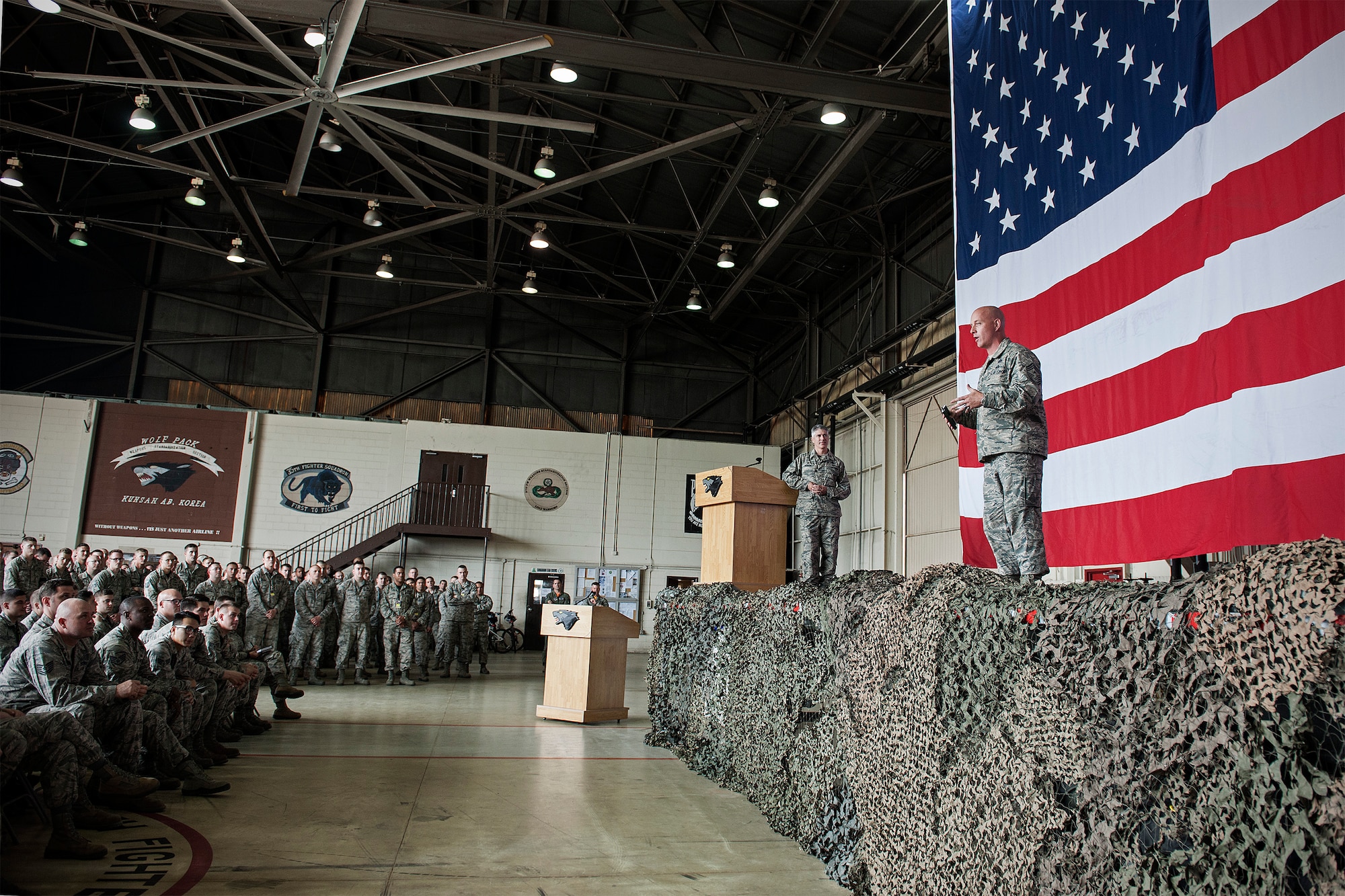 Chief Master Sgt. Daniel “Wolf Chief” Simpson, 8th Fighter Wing command chief, addresses 8th Maintenance Group Airmen during a commander’s call at Kunsan Air Base, Republic of Korea, May 22, 2015. Wolf Chief and Col. Jeremy “Wolf” Sloane, 8th FW commander, stressed the necessity for combat readiness and strengthening relationships during their first round of all-calls with the Wolf Pack. (U.S. Air Force photo by Senior Airman Katrina Heikkinen/Released)