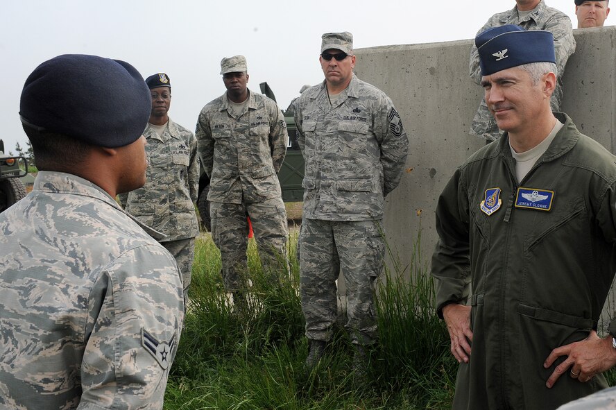 Col. Jeremy “Wolf” Sloane, 8th Fighter Wing commander, receives a mission brief prior to taking command at Kunsan Air Base, Republic of Korea, May 19, 2015. During Sloane’s first week with the Wolf Pack, he received a mission brief, assumed command as Wolf 55, and conducted five commander’s calls to meet the men and women of Kunsan. (U.S. Air Force photo by Senior Airman Divine Cox/Released)