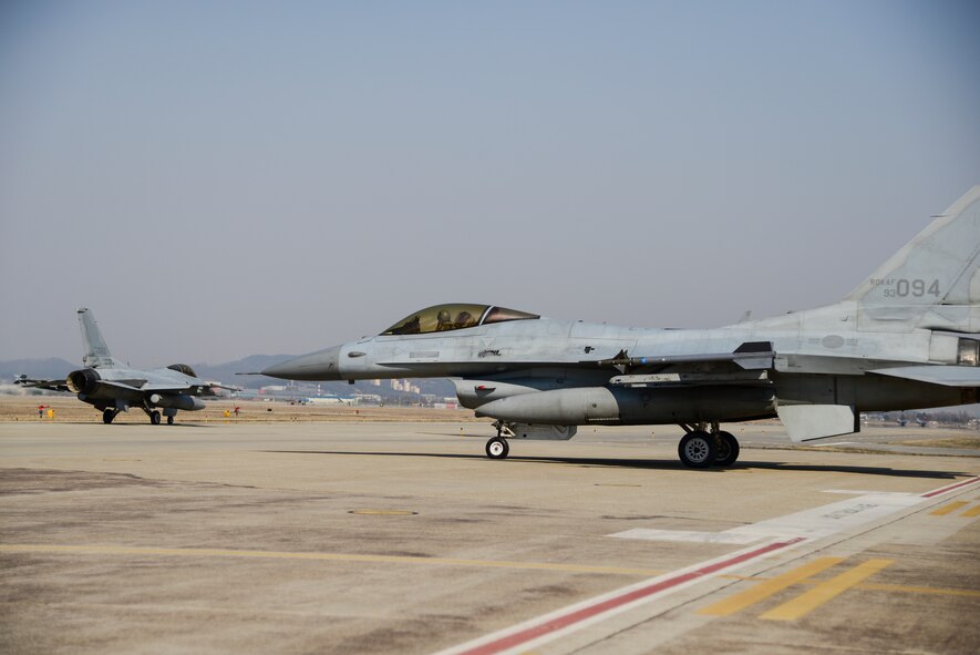 Republic of Korea air force F-16 Fighting Falcons taxi to the runway during Buddy Wing 15-3 March 25, 2015, at Osan Air Base, ROK. The program places both ROKAF and U.S. Air Force pilots in the same briefings and flying rules that the host unit flies under. (U.S. Air Force photo by Senior Airman Matthew Lancaster)