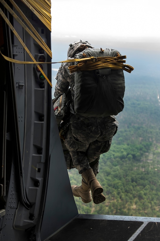 A soldier exits an Air Force C-17 Globemaster III during a static line ...