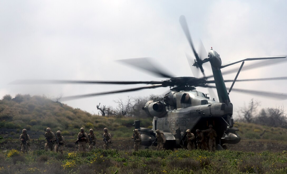 U.S. Marines exit a CH-53 Super Stallion during a company-sized assault ...