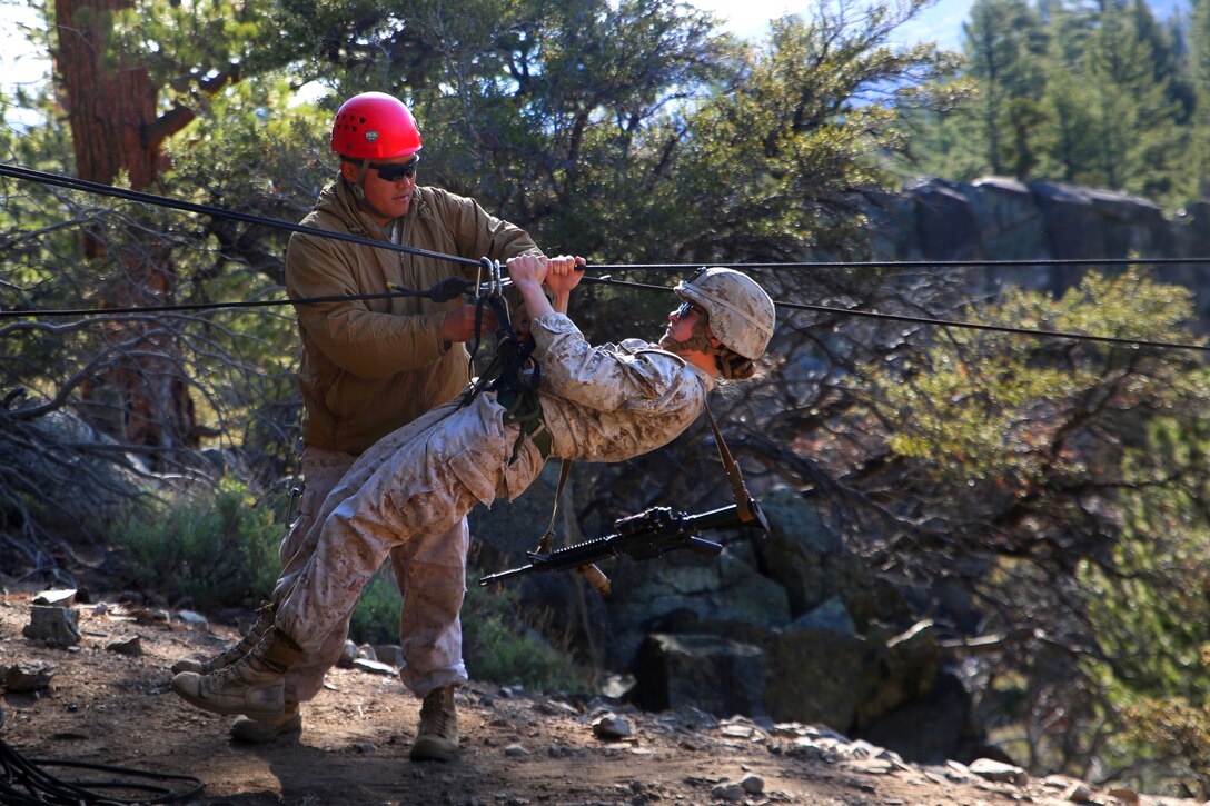 Marine Corps Staff Sgt. Raphael Palisoc, rear, secures Sgt. Rebecca Rutherford onto a rope bridge during her final Marine Corps Operational Test and Evaluation Activity assessment at Marine Corps Mountain Warfare Training Center Bridgeport, Calif., May 18, 2015. Palisoc is a mountain leader at the training center and Rutherford is a mortarman assigned to Weapons Company, Ground Combat Element Integrated Task Force.