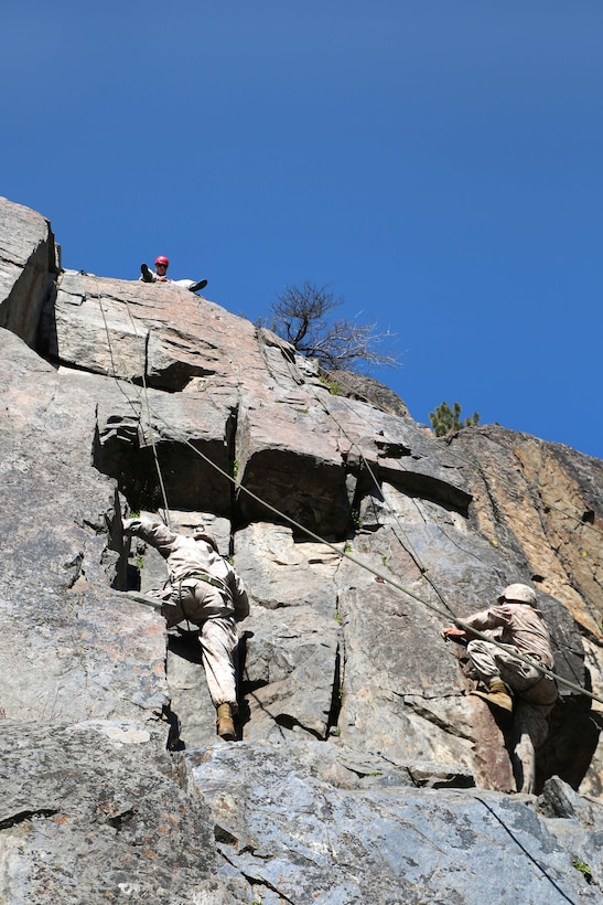 Marines climb a 40-foot cliff face during their final Marine Corps Operational Test and Evaluation Activity assessment at Marine Corps Mountain Warfare Training Center Bridgeport, Calif., May 18, 2015.