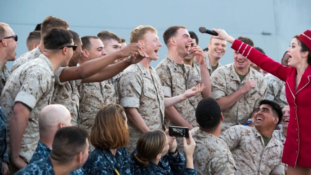 The United Service Organizations (USO) singer lets the Marines sing along during a free concert for Marines and sailors aboard the USS San Antonio en route from Norfolk, Va., to Fleet Week in New York, May 19, 2015. Approximately 1,800 Marines, sailors and Coast Guardsmen participate in this year’s annual Fleet Week New York May 20-26, 2015. Fleet Week provides the people of New York and surrounding area a chance to see the capabilities of the sea services, as well getting the opportunity to meet the Marines, sailors and Coast Guardsmen. 