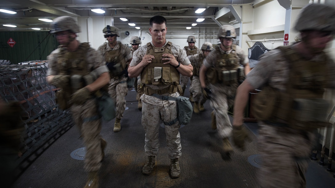 Sergeant Matthew Sanford, a squad leader of 2nd Platoon, Charlie Company, 1st Battalion, 6th Marines Regiment, watches as his Marines practice insertion and extraction drills aboard the USS San Antonio LPD May 19, 2015.  The company will be participating in Fleet Week New York, New York to showcase what Marines and joint services have to offer in defense support.  