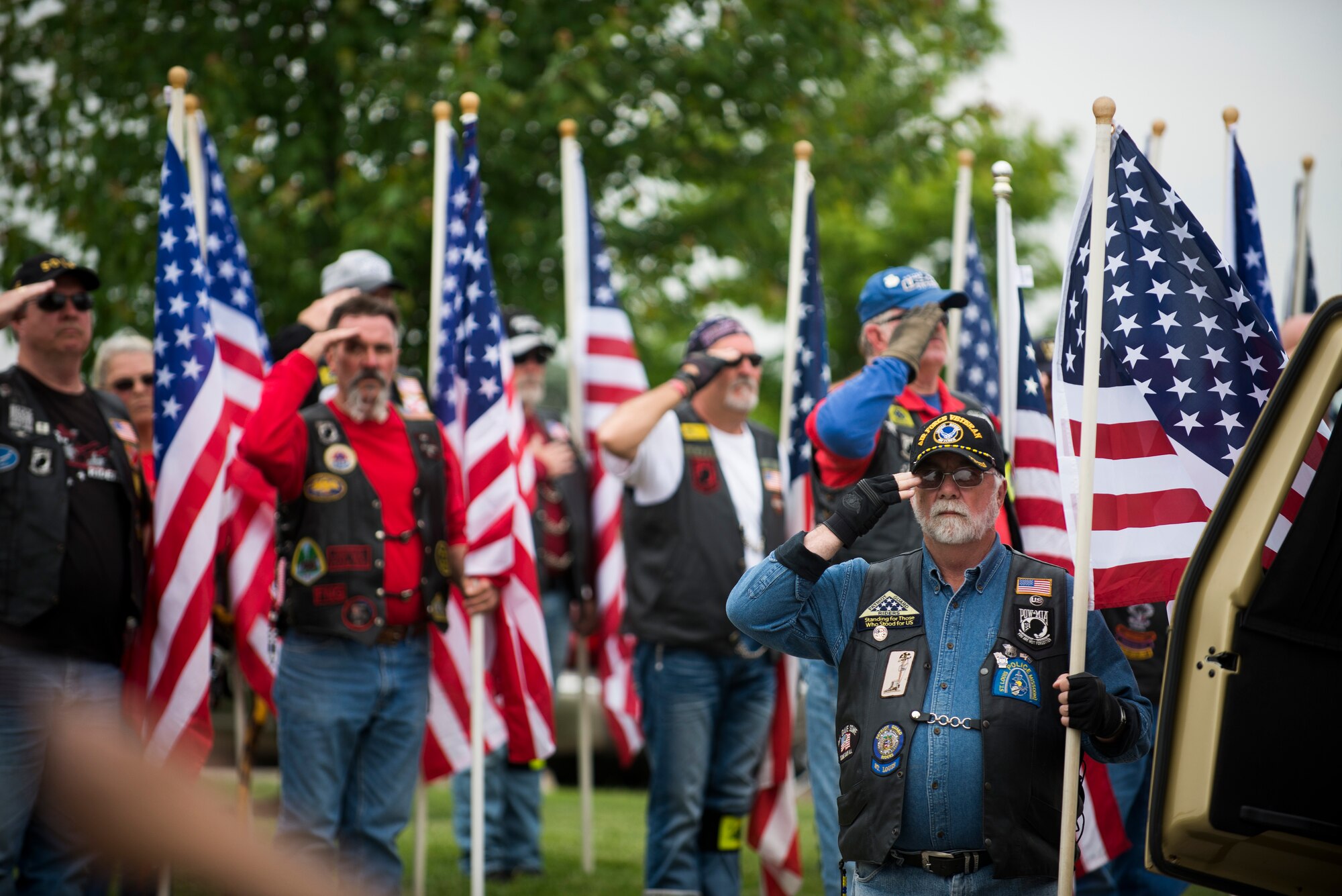 Members of the Patriot Guard Riders render a salute during the funeral of Tech. Sgt. Louis Clever May 22, 2015, at Jefferson Barracks National Cemetery, St. Louis, Missouri. Clever passed away in 1969, when his plane went down; his son Paul travelled to Laos to discover his remains. (U.S. Air Force photo by Staff Sgt. Clayton Lenhardt/Released)