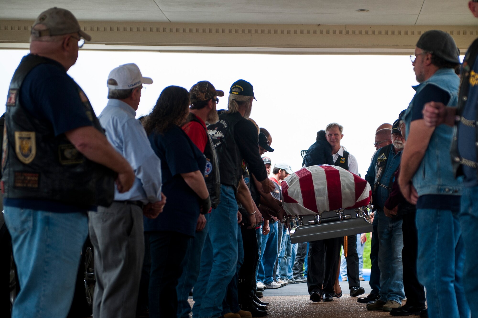 Supporters transfer Tech. Sgt. Louis Clever to a hearse prior to his burial May 20, 2015, at the Kutis Funeral Home, St. Louis, Missouri. Clever's son, Paul, travelled to Laos to find the remains of his father. (U.S. Air Force photo by Staff Sgt. Clayton Lenhardt/Released)