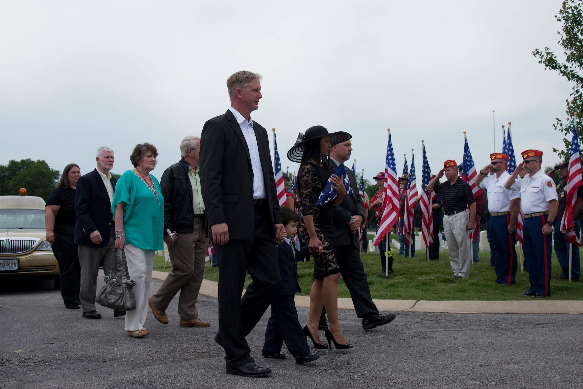Family and friends of Tech. Sgt. Louis Clever walk to where his casket will be buried at the Jefferson Barracks National Cemetery, St. Louis, Missouri, May 22, 2015. Clever is a Vietnam Veteran whose remains were just recently found and identified in Southern Laos. (U.S. Air Force Photo by Airman 1st Class Megan Friedl