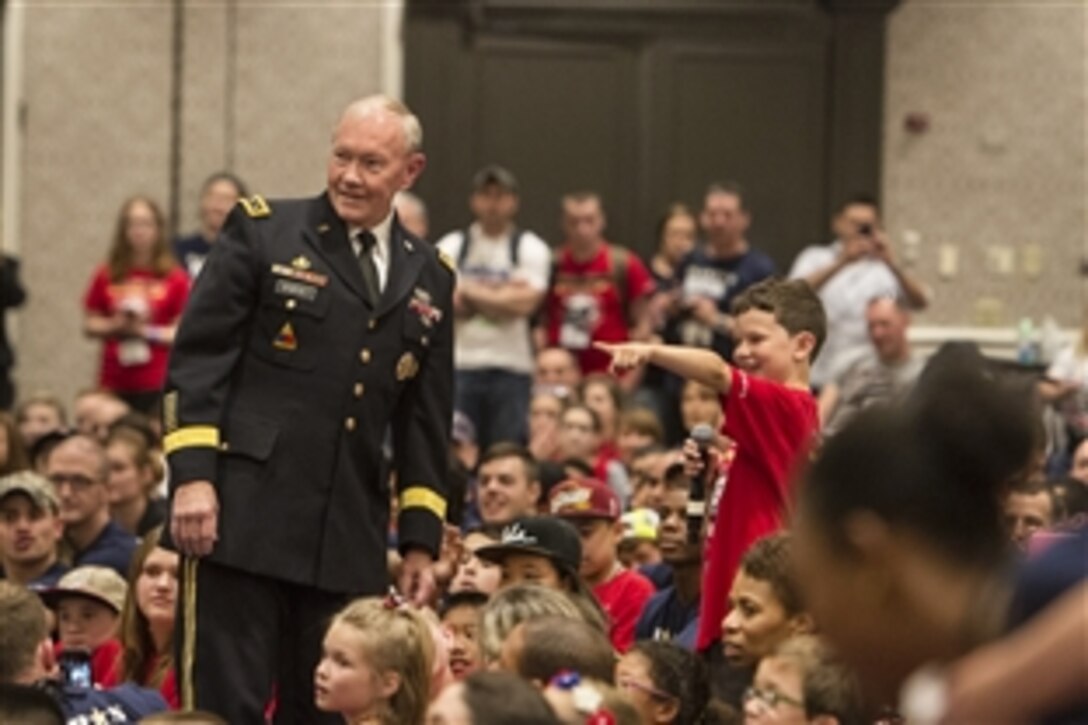 Army Gen. Martin E. Dempsey, chairman of the Joint Chiefs of Staff, interacts with children at the 21st annual seminar and Good Grief Camp for Young Survivors through the Tragedy Assistance Program for Survivors in Arlington, Va., May 22, 2015. The program, known as TAPS, offers support for military families who have lost a family member serving in the military.