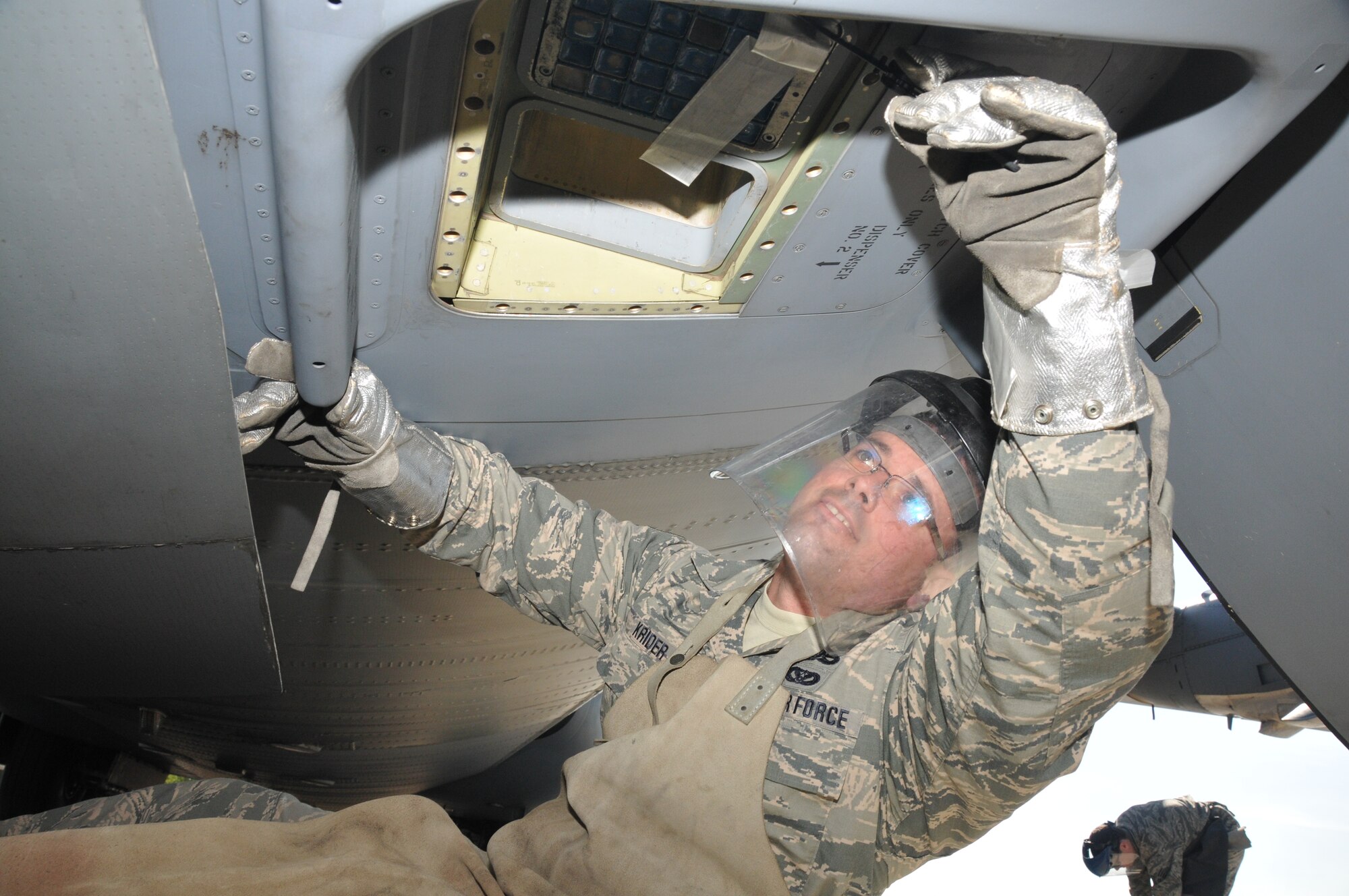 The non-commissioned officer in charge of operations, 104th Explosive Ordnance Disposal Flight, Barnes Air National Guard Base, Westfield, Mass., removes flares from a C-130 aircraft May 13, 2015, Ramstein Air Base, Germany. This was part of an EOD exercise and fulfilled their yearly aircraft-training requirement. (U.S. Air National Guard photo by 2nd Lt. Bonnie Harper/Released)