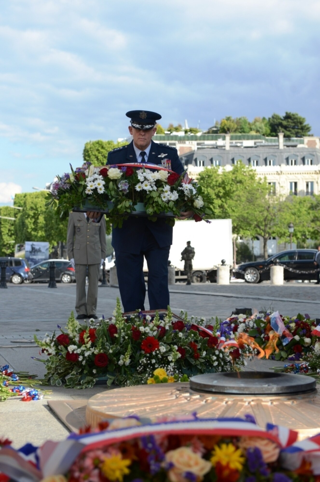 Gen. Frank Gorenc, U.S. Air Forces in Europe - Air Forces Africa commander, presents a wreath to honor and pay tribute to the Tomb of the Unknown Soldier, who is buried beneath the Arc de Triomphe, in Paris, France, May 24, 2015. The general attended the solemn ceremony with approximately 100 U.S. and French service members, families, and civilians to commemorate Memorial Day.  (U.S. Air Force photo by Maj. Sheryll Klinkel/Released)