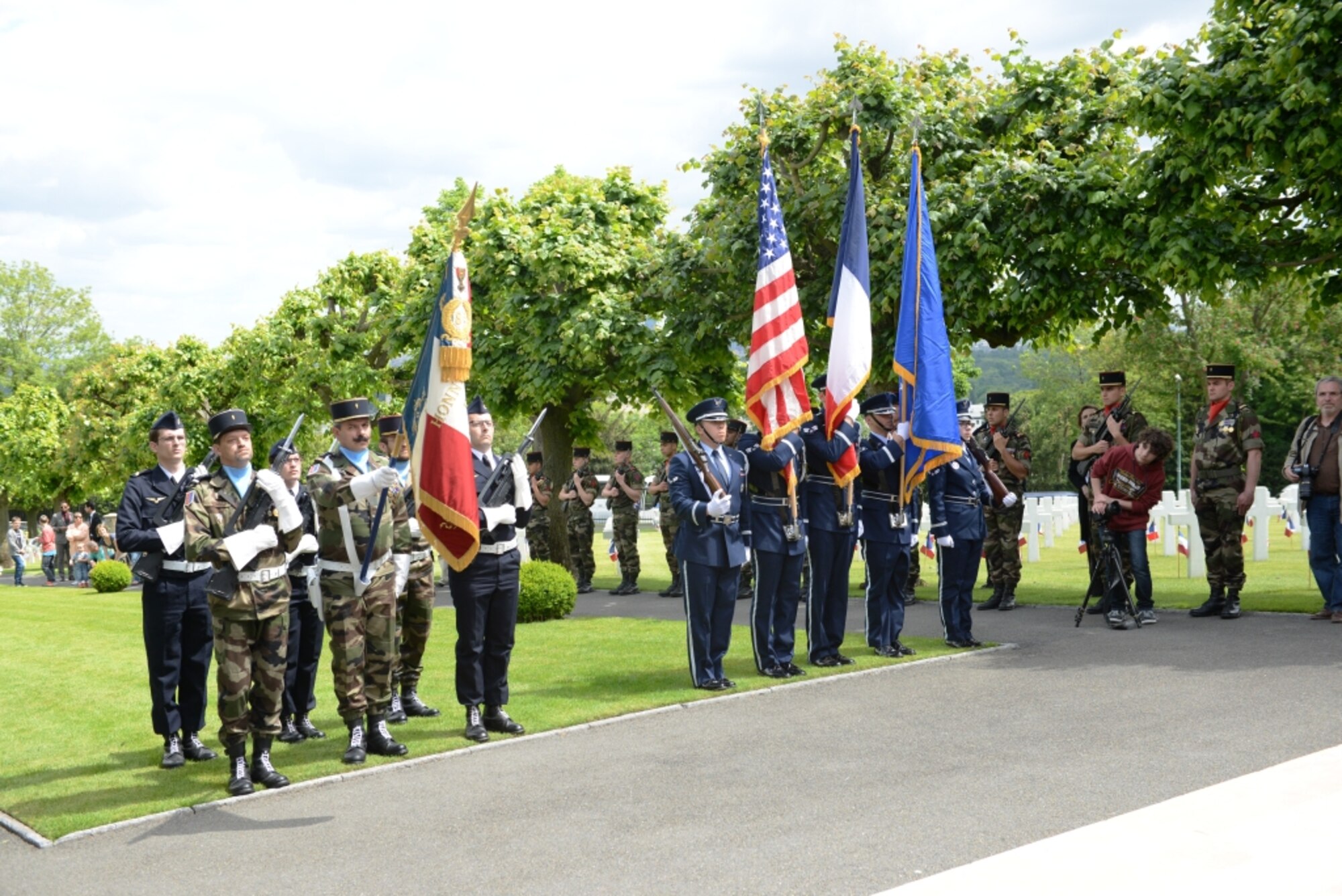 Honor Guards from the 86th Airlift Wing, Ramstein Air Base, Germany, the French Military, and American Legion Post One, present the colors during a Memorial Day ceremony at Suresnes American Cemetery, near Paris, France, May 24, 2015.  The cemetery contains the burials of 1,565 and 974 men and women missing in actions. The cemetery is the only American cemetery in Europe that shelters fallen comrades from both world wars.  (U.S. Air Force photo by Maj. Sheryll Klinkel/Released)