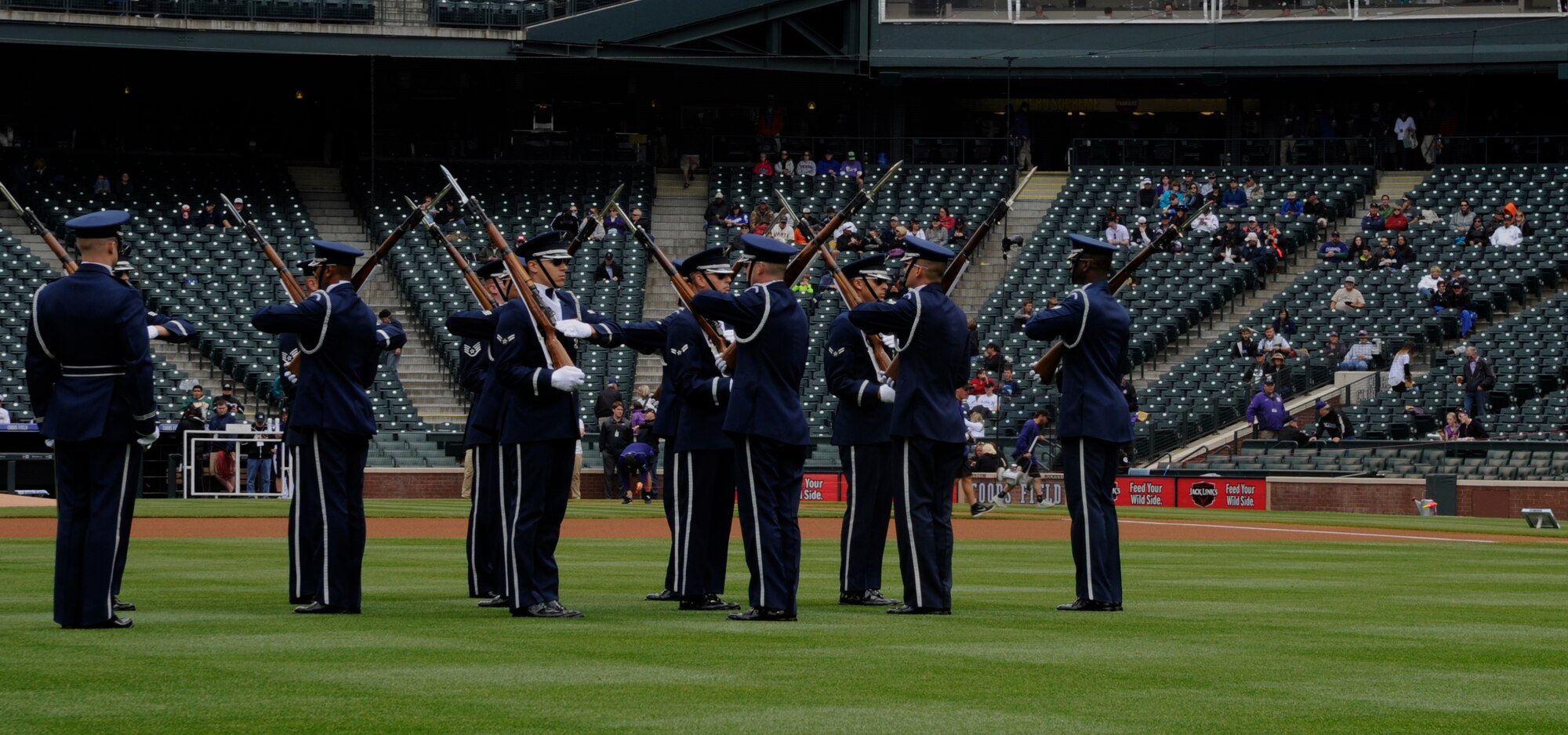 The United Stated Air Force Honor Guard Drill Team performs at a Colorado Rockies game against the San Francisco Giants at Coors Field in Denver, Colo., May 24, 2015. The Drill Team promotes the Air Force mission by showcasing drill performances at public and military venues to recruit, retain and inspire Airmen. (U.S. Air Force photo by Senior Airman Preston Webb/RELEASED)