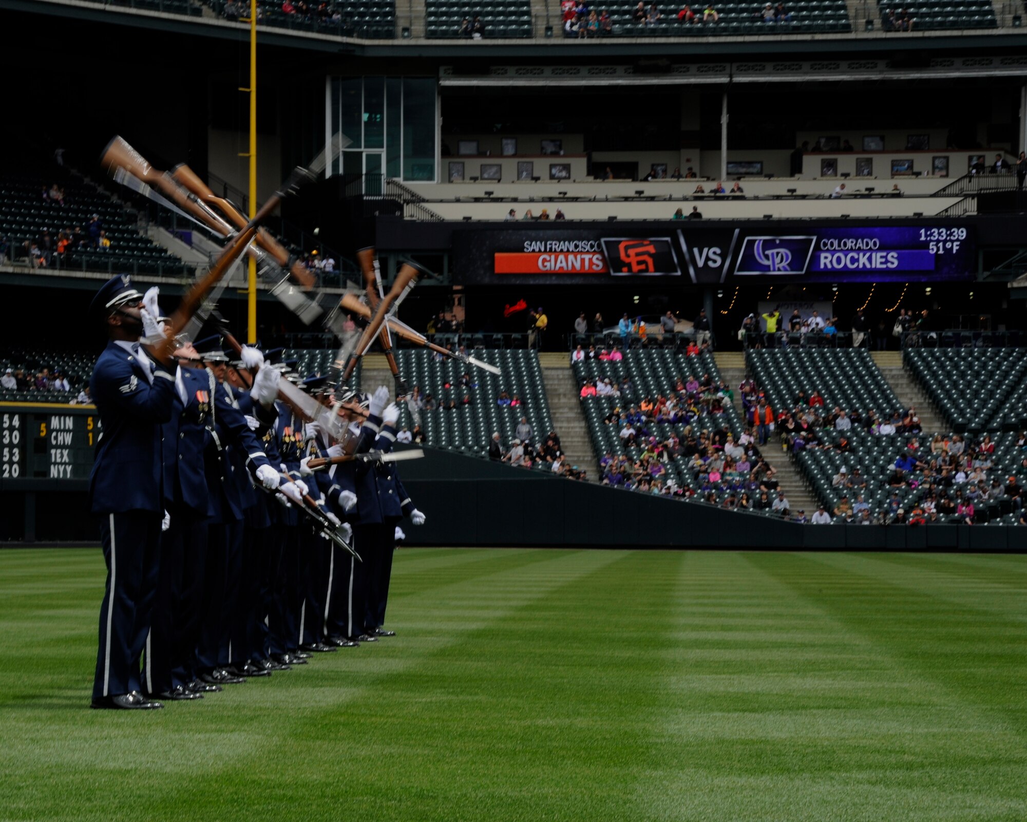 The United States Air Force Honor Guard Drill Team tosses their M-1 Garand rifles during a performance at a Colorado Rockies game against the San Francisco Giants at Coors Field in Denver, Colo., May 24, 2015. The Drill Team promotes the Air Force mission by showcasing drill performances at public and military venues to recruit, retain and inspire Airmen. (U.S. Air Force photo by Senior Airman Preston Webb/RELEASED)