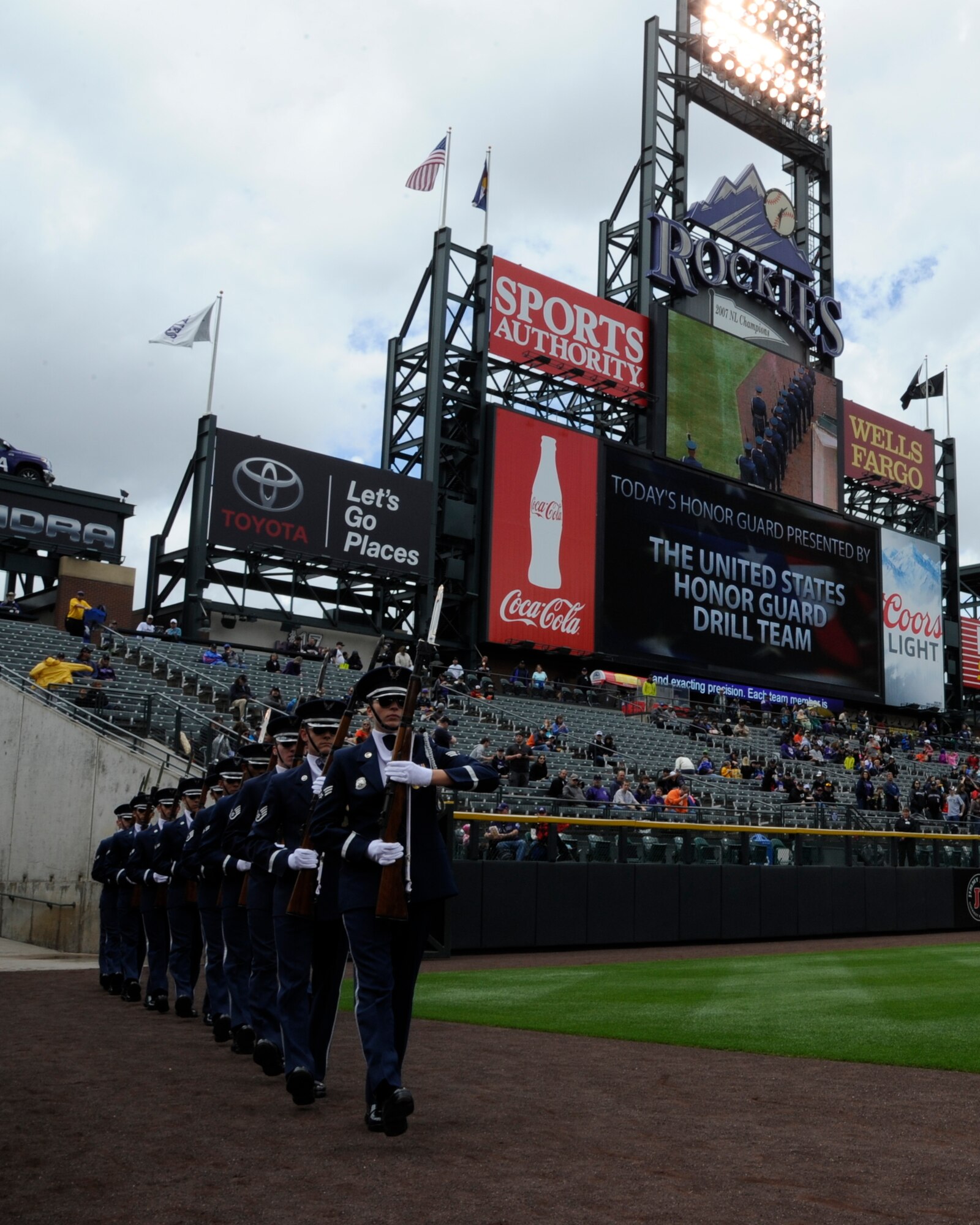he United States Air Force Honor Guard Drill Team enters the field at a Colorado Rockies game against the San Francisco Giants at Coors Field in Denver, Colo., May 24, 2015. The Drill Team promotes the Air Force mission by showcasing drill performances at public and military venues to recruit, retain and inspire Airmen. (U.S. Air Force photo by Senior Airman Preston Webb/RELEASED)