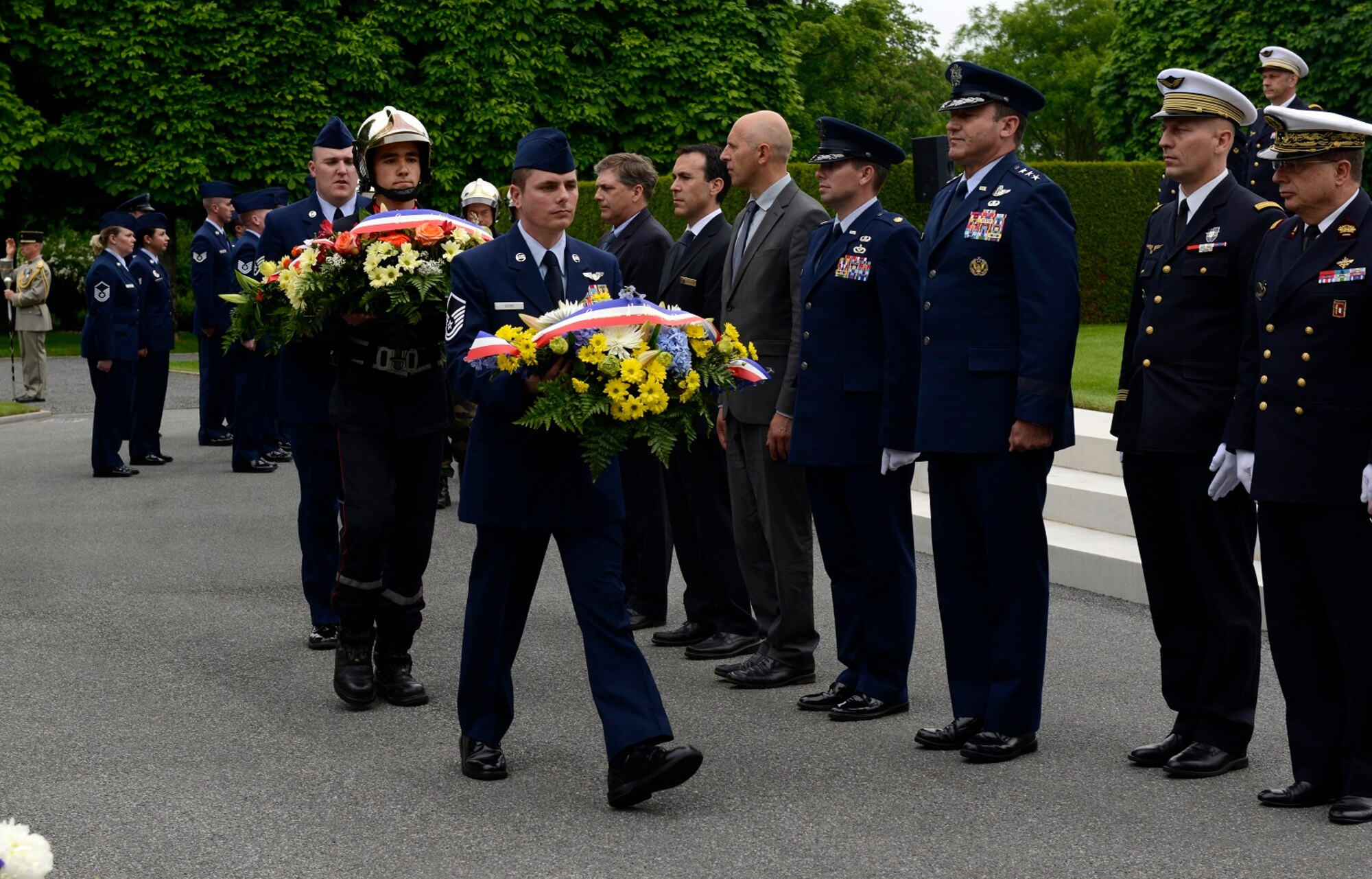 Wreaths are presented to be laid during a Memorial Day ceremony May 24, 2015, at St. Mihiel American Cemetery in Thiaucourt, France. The ceremony was one of many held throughout Europe during Memorial weekend to honor the sacrifices of fallen American servicemembers. (U.S. Air Force photo/Airman 1st Class Tryphena Mayhugh)