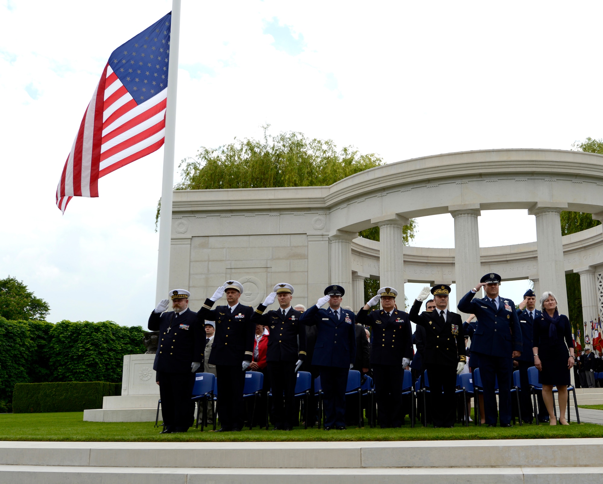 Lt. Gen. Tom Jones, U.S. Air Force in Europe and Air Forces Africa vice commander, and other honored guests render salutes during the playing of the American National Anthem while attending a Memorial Day ceremony May 24, 2015, at St. Mihiel American Cemetery in Thiaucourt, France. The ceremony was one of many held throughout Europe during Memorial weekend to honor the sacrifices of fallen servicemembers. (U.S. Air Force photo/Airman 1st Class Tryphena Mayhugh)