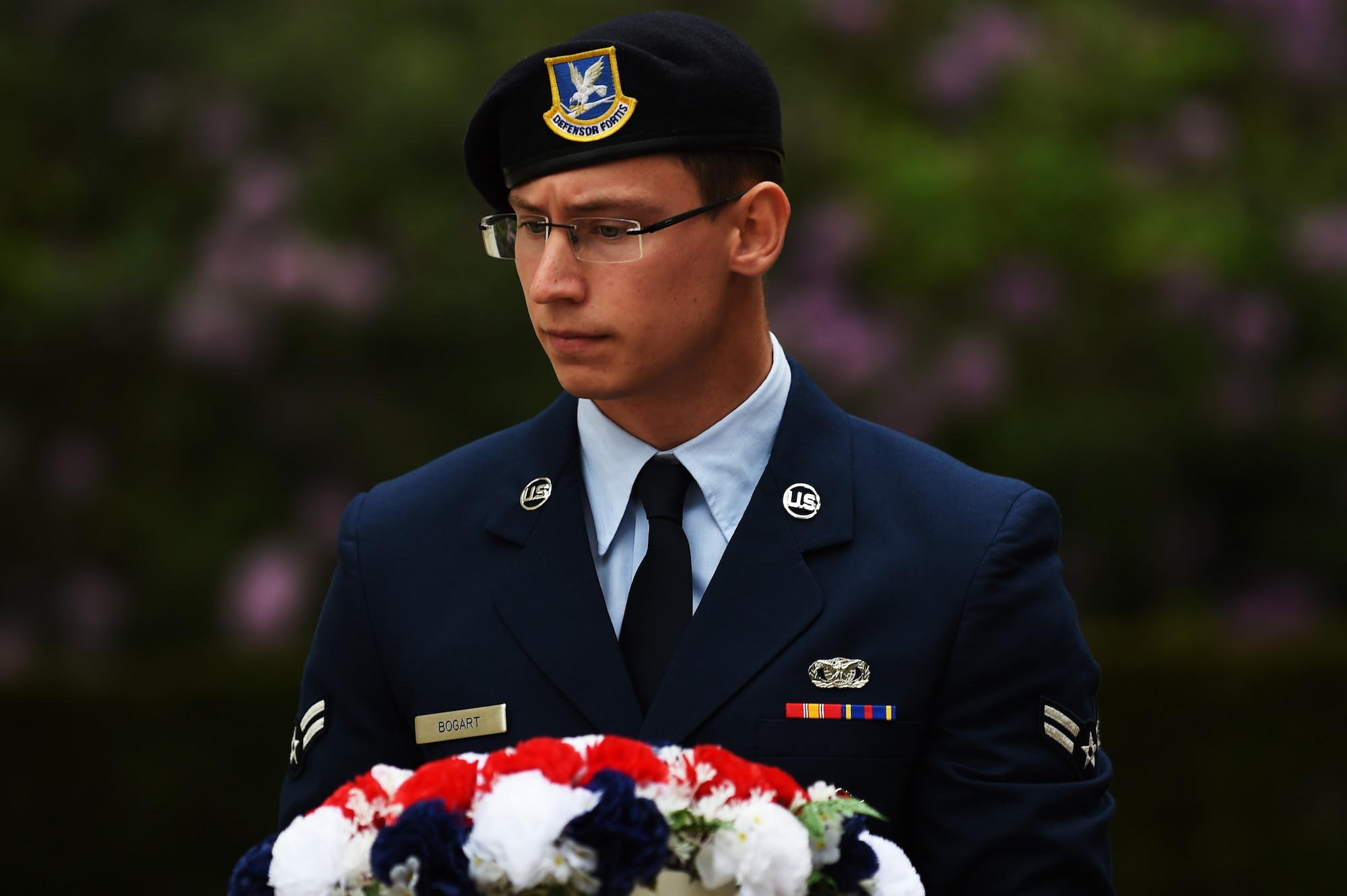 U.S. Air Force Airman 1st Class Jared Bogart, 422nd Security Forces Squadron patrolman, carries a wreath during a Memorial Day ceremony at Brookwood American Military Cemetery, England, May 24, 2015. Bogart, along with representatives from the United States and United Kingdom, laid wreaths to honor the sacrifice of those who gave their lives in the service of their country. (U.S. Air Force photo by Staff Sgt. Jarad A. Denton/Released)