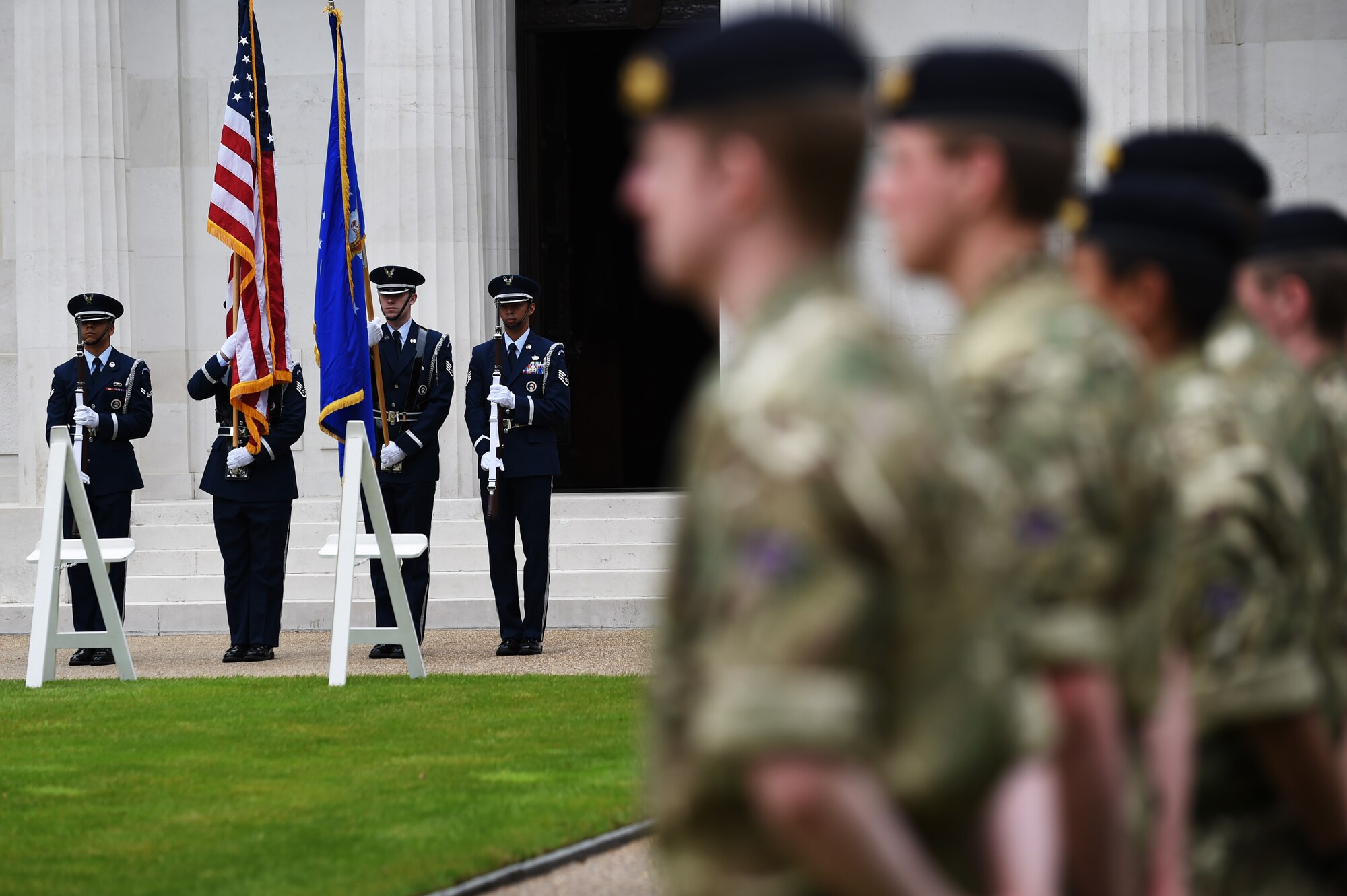 U.S. Air Force Airmen from the 422nd Air Base Group Honor Guard, flanked by Soldiers from the British Army, present the colors during a Memorial Day ceremony at Brookwood American Military Cemetery, England, May 24, 2015. Service members from both nations came together to honor the sacrifices of those buried at the cemetery and listed on the wall of the missing, inside the chapel. (U.S. Air Force photo by Staff Sgt. Jarad A. Denton/Released)