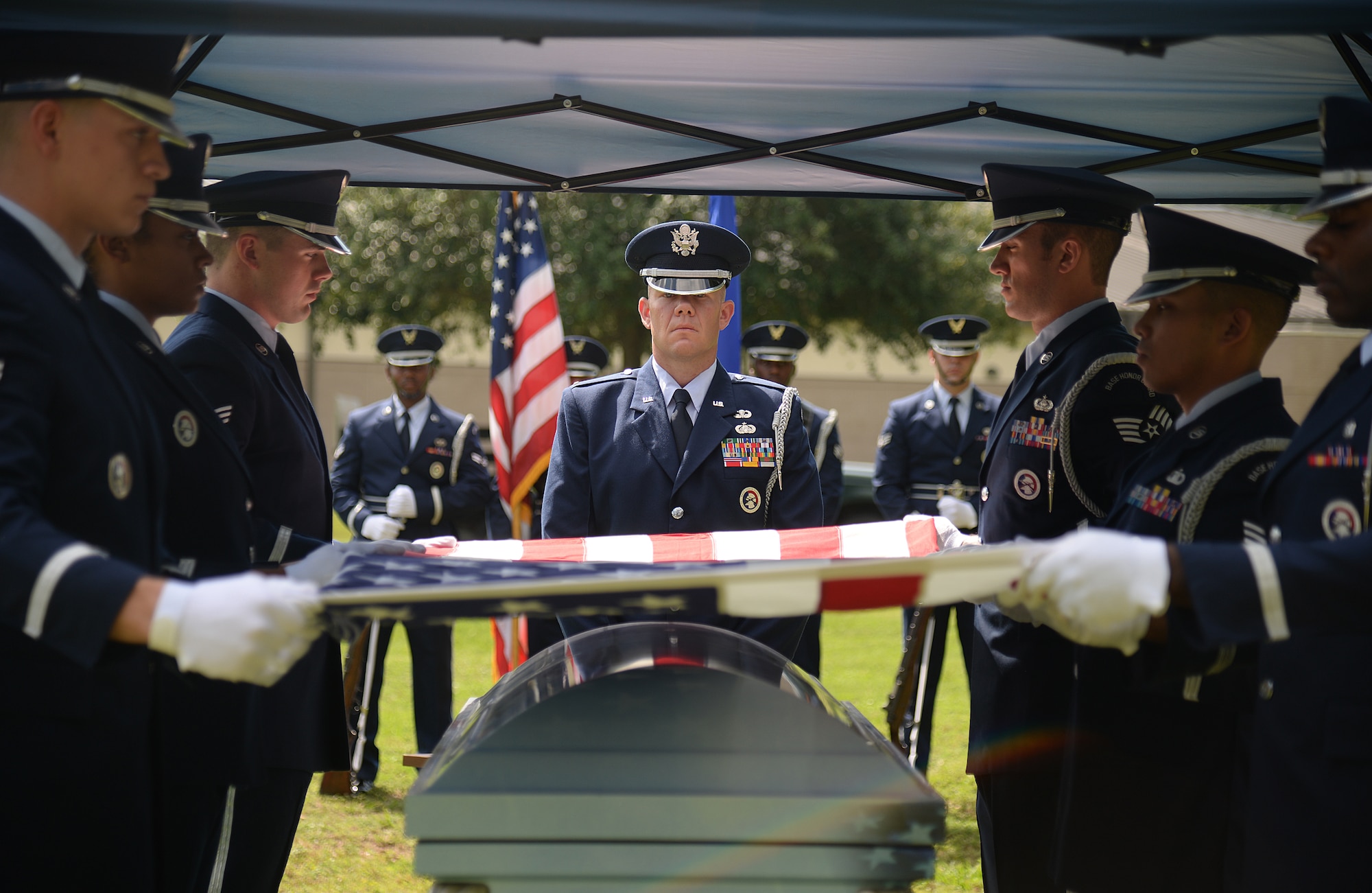 Honor guard pallbearers fold the American flag during a mock active-duty funeral, May 20, 2015, at Keesler Air Force Base, Miss. Three members of the Air Force Honor Guard Mobile Training Team conducted a seven-day course for honor guard members from Keesler, Columbus AFB, Miss., Maxwell AFB, Ala., and the 159th Fighter Wing Louisiana Air National Guard. Participants were trained on firing party, flag presentations and pallbearer duties. (U.S. Air Force photo by Senior Airman Holly Mansfield)