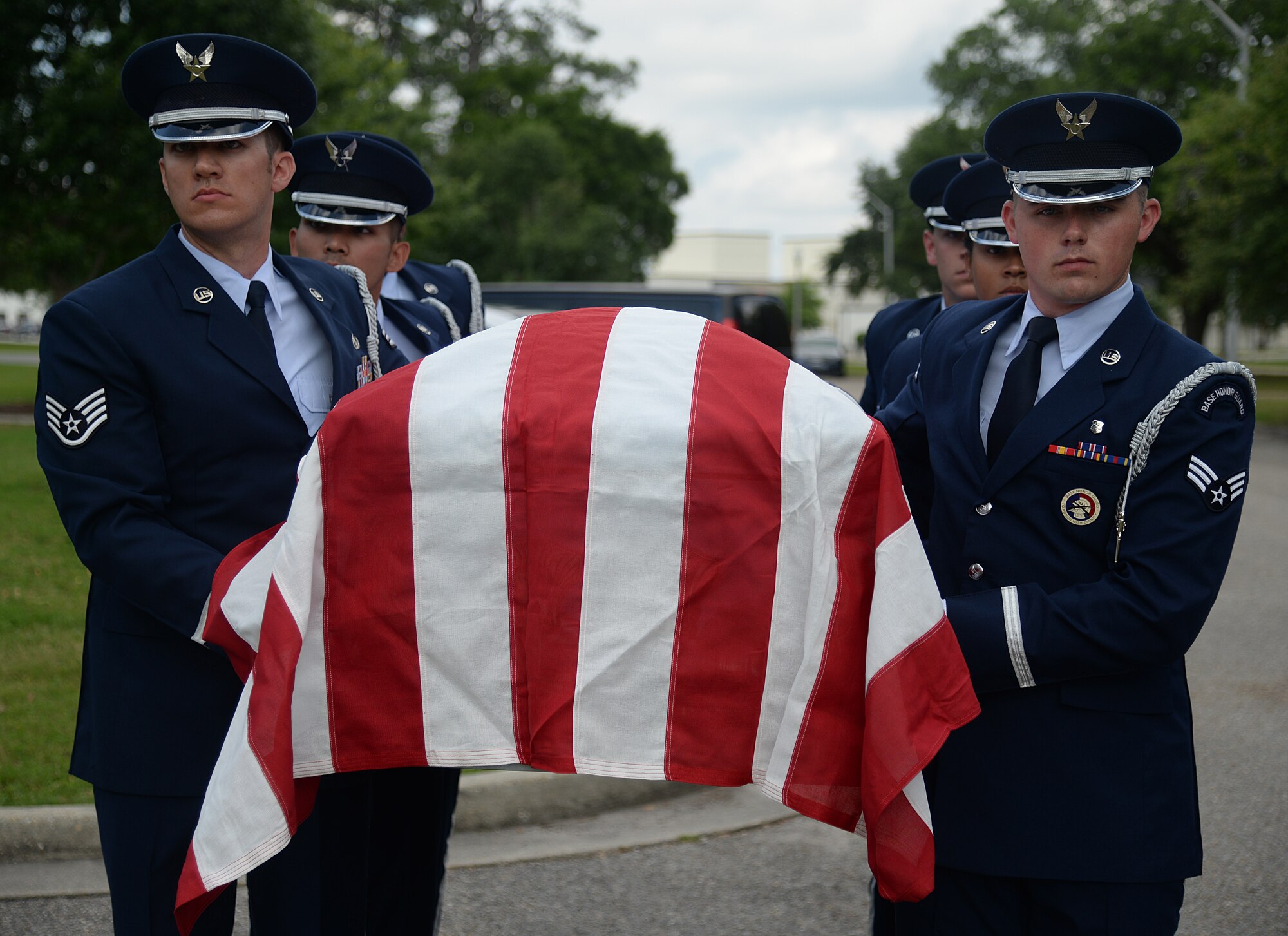 Base honor guard pallbearers carry a casket in a mock active-duty funeral, May 20, 2015, at Keesler Air Force Base, Miss. Three members of the Air Force Honor Guard Mobile Training Team conducted a seven-day training course for honor guard members from Keesler, Columbus AFB, Miss., Maxwell AFB, Ala., and the 159th Fighter Wing Louisiana Air National Guard. Honor guard members were trained on firing party, flag presentations and pallbearer duties. (U.S. Air Force photo by Senior Airman Holly Mansfield)