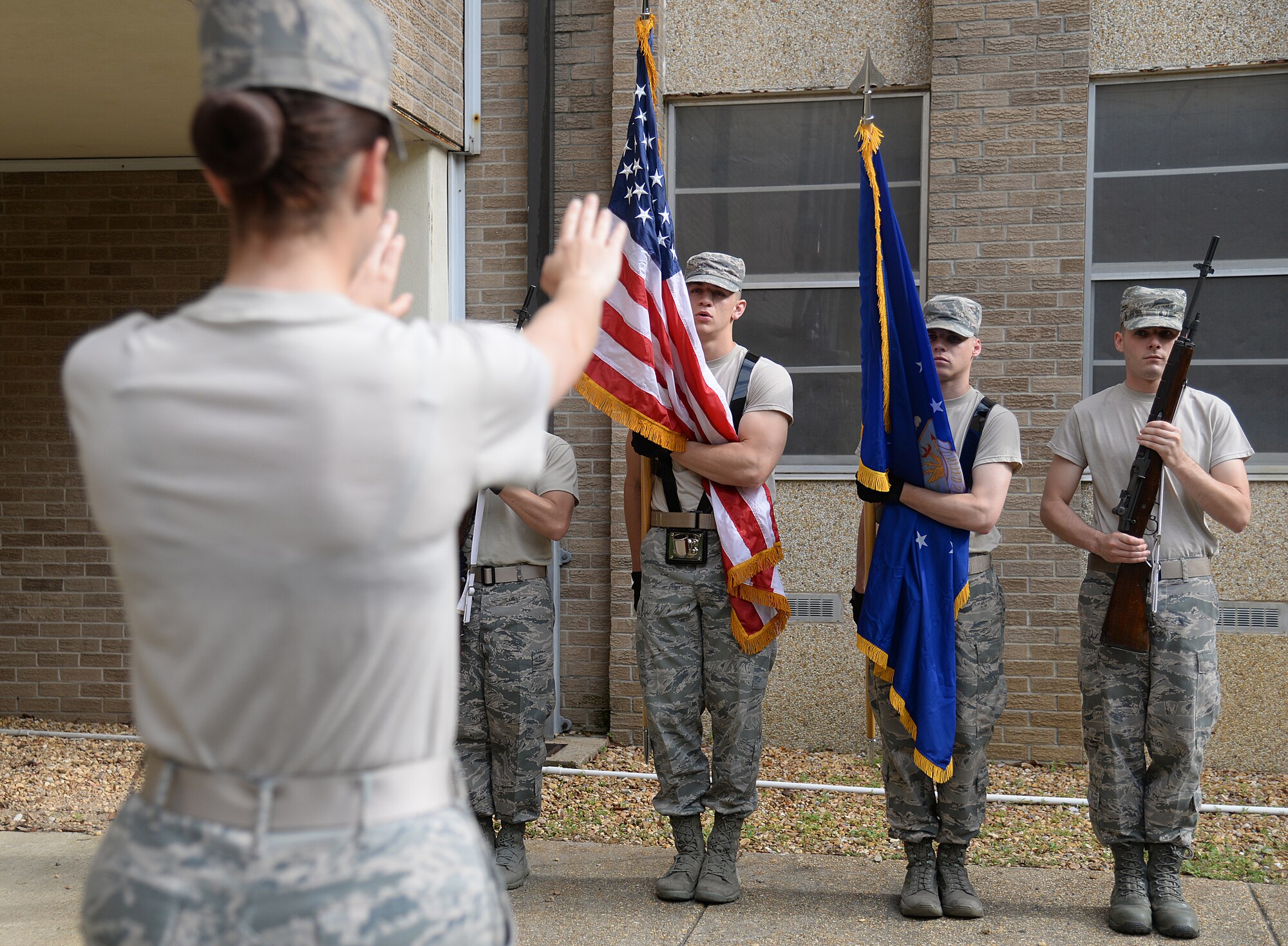 Airman 1st Class Amber Marcum, Air Force Honor Guard Mobile Training Team instructor, demonstrates proper colors techniques, May 13, 2015, at Keesler Air Force Base, Miss. Three members of the mobile training team conducted a seven-day course for honor guard members from Keesler, Columbus AFB, Miss., Maxwell AFB, Ala., and the 159th Fighter Wing Louisiana Air National Guard. Participants were trained on firing party, flag presentations and pallbearer duties. (U.S. Air Force photo by Senior Airman Holly Mansfield)