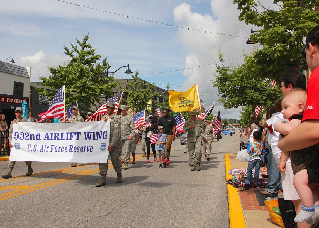 Members of the 932nd Airlift Wing took time out to remember the nation's fallen military by walking in the Belleville Memorial Day Parade, May 25, in Belleville, Ill. These Air Force Reserve Command members live and work in the community. The 932nd AW is the only Air Force Reserve Command flying wing that flies the C-40C which is used to provide world-class airlift for U.S. national and military leaders. (U.S. Air Force photo by Maj. Stan Paregien)