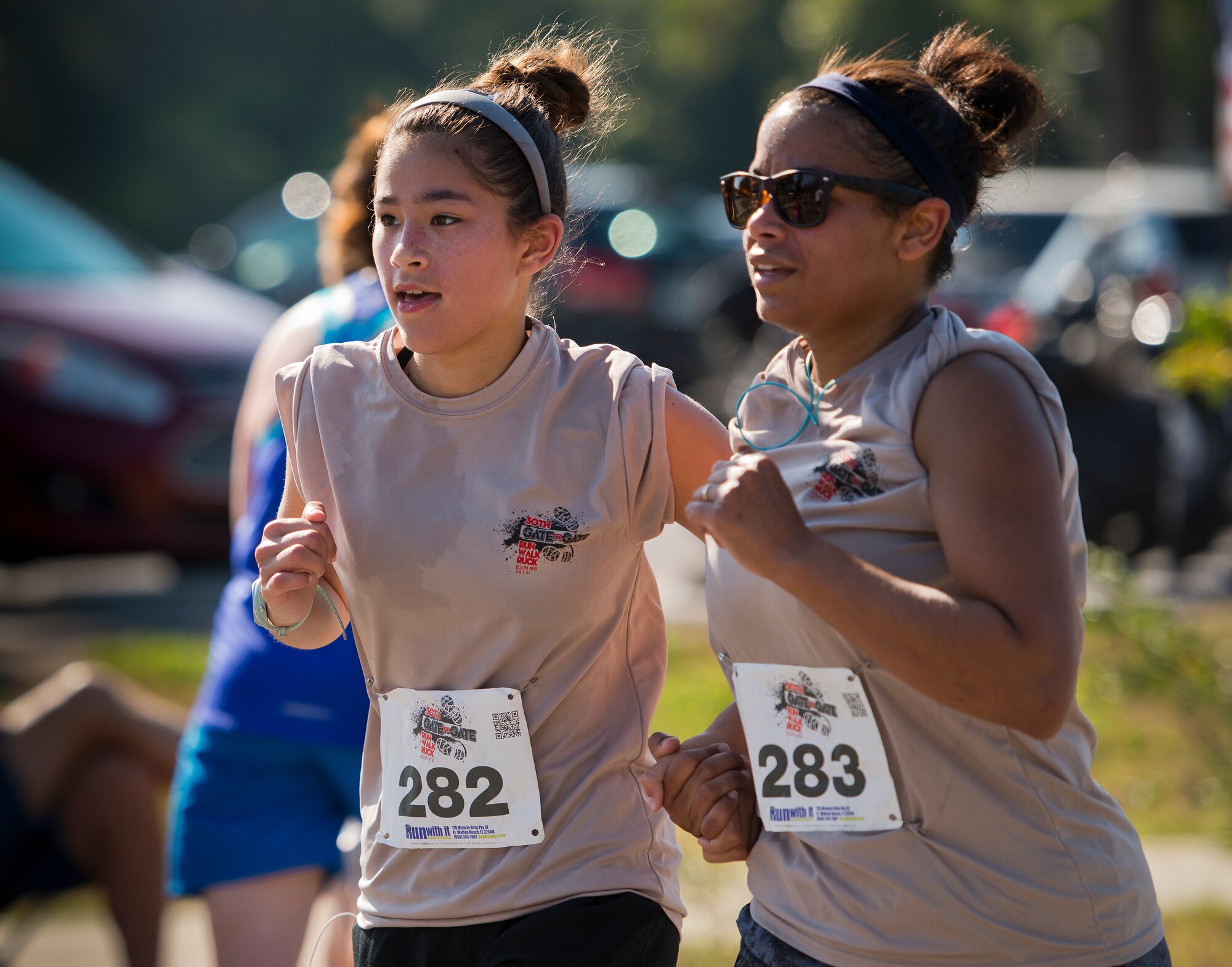 Devin and Teresa Fritz sprint hand-in-hand toward the finish line of the 30th Anniversary Memorial Gate to Gate run May 23 at Eglin Air Force Base, Fla.  More than 1,500 participated in this year’s event.  (U.S. Air Force photo/Samuel King Jr.)