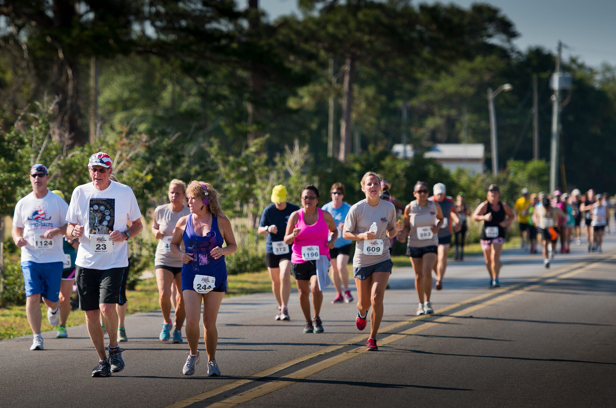 Mike Anderson, Fort Walton Beach mayor, leads a pack of runners toward the finish line of the 30th Anniversary Memorial Gate to Gate run May 23 at Eglin Air Force Base, Fla.  More than1,500 participated in this year’s event.  (U.S. Air Force photo/Samuel King Jr.)