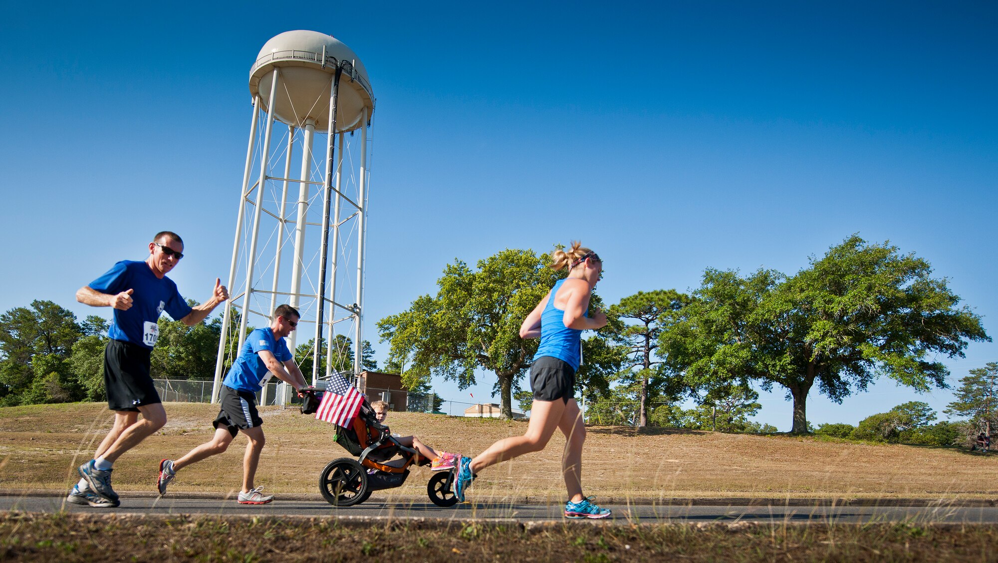 Mike Weaver, 919th Special Operations Wing, and other runners climb up the final hill toward the finish line during the 30th Anniversary Memorial Gate to Gate run May 23 at Eglin Air Force Base, Fla.  More than 1,500 participated in this year’s event.  (U.S. Air Force photo/Samuel King Jr.)